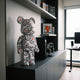 Heartbeat Groove Bear Sculpture - 70cm by Giant Sculptures, white resin bear with black wavy lines and red hearts, shown on a media console in a home office.