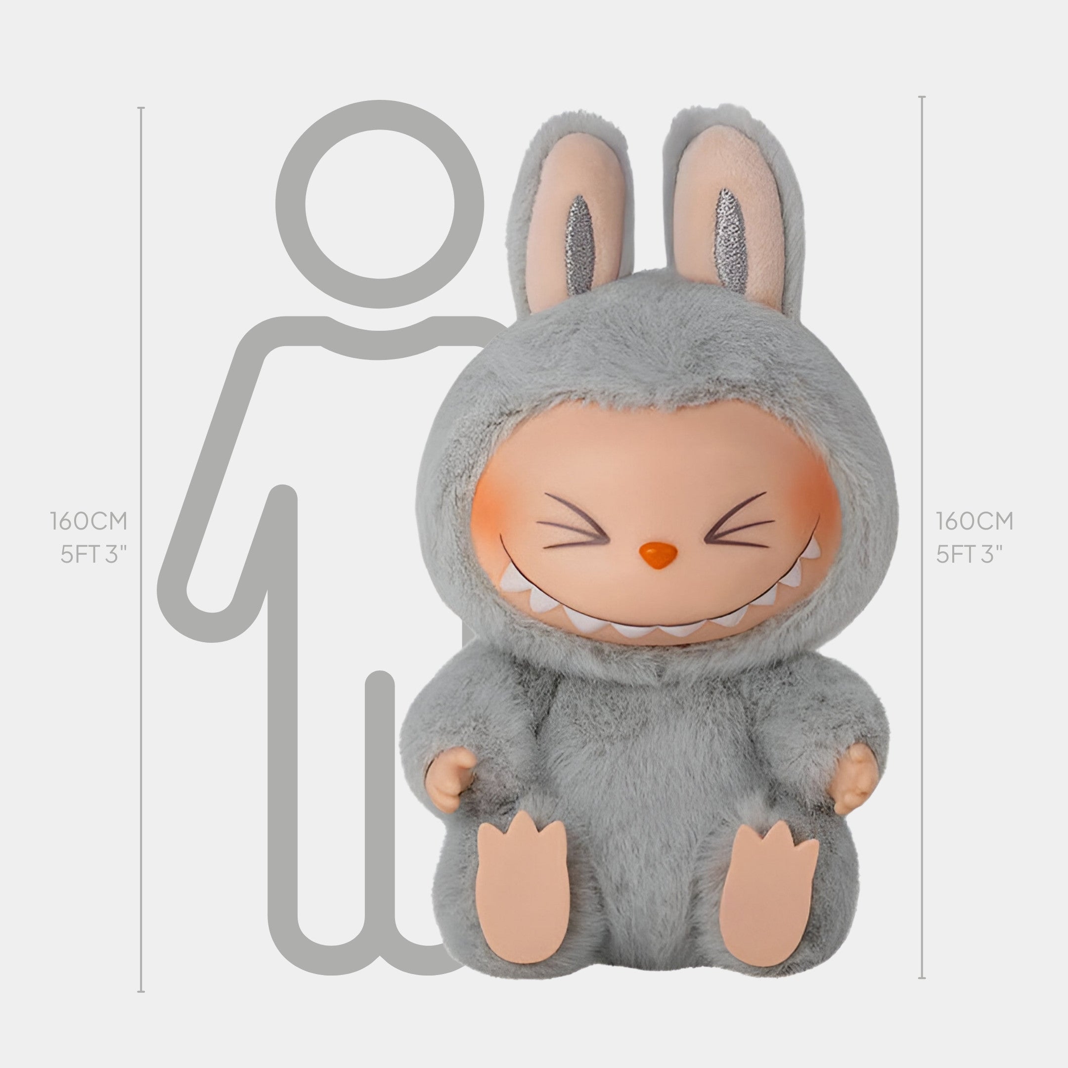 The Fluffy Monsters Cheeky Grey Labubu Sculpture by Giant Sculptures stands 160cm tall, matching the height of a 5 ft 3 in human outline, and features Labubu in a grey bunny suit with big ears and a toothy grin.