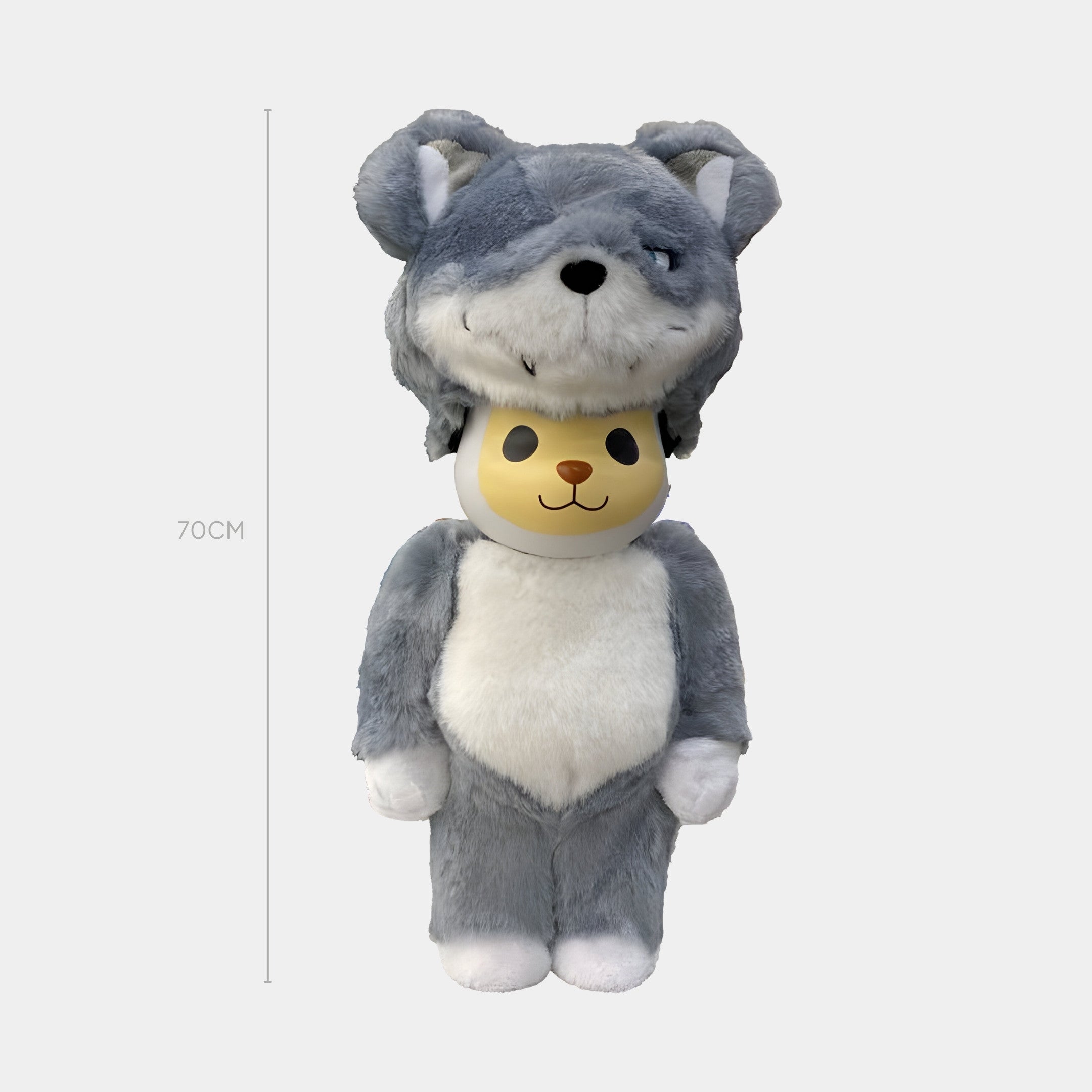 The Hidden Howl Fur Bear Sculpture by Giant Sculptures is a 70cm plush bear dressed in a gray and white wolf costume with faux fur and a large wolf hood, standing upright against a plain background.