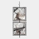 The Vistarte Neutral Abstract Dual Panel Metal Wall Art by Giant Sculptures features two abstract black and white paintings with dynamic brushstrokes in minimalist black frames, mounted vertically on a metal rod against a light grey background.