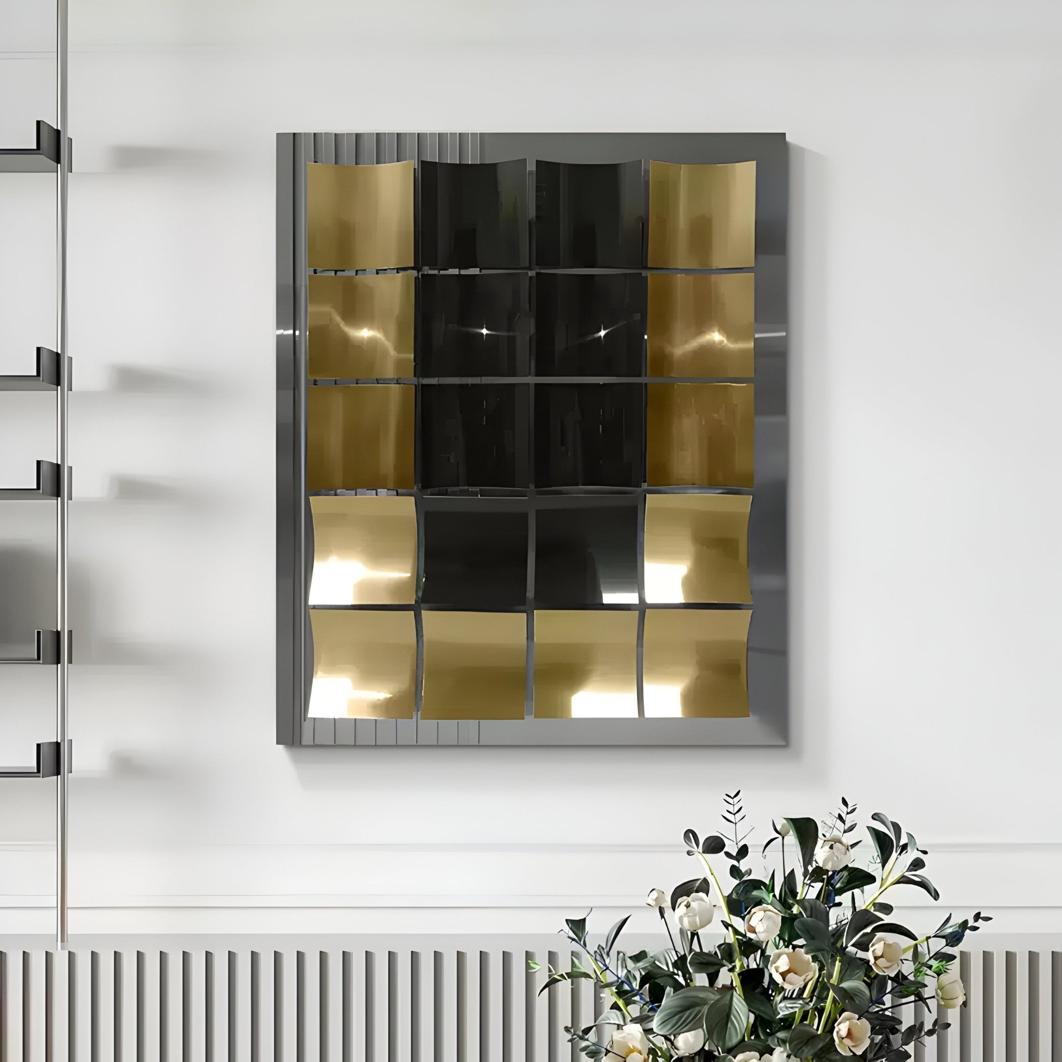 The Onda Black & Gold Rippled Geometric Metal 3D Wall Art by Giant Sculptures is a decorative piece featuring wavy reflective panels for a distorted effect. A potted plant with white flowers below complements this artistic creation, ideal for contemporary interiors.