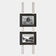The Imperia Temple and Misty Landscape Dual Frame Metal Wall Art by Giant Sculptures features two black-framed black-and-white photos—temple wall art with a pagoda above, and a misty mountain scene below—on a modern gold and black pole display.