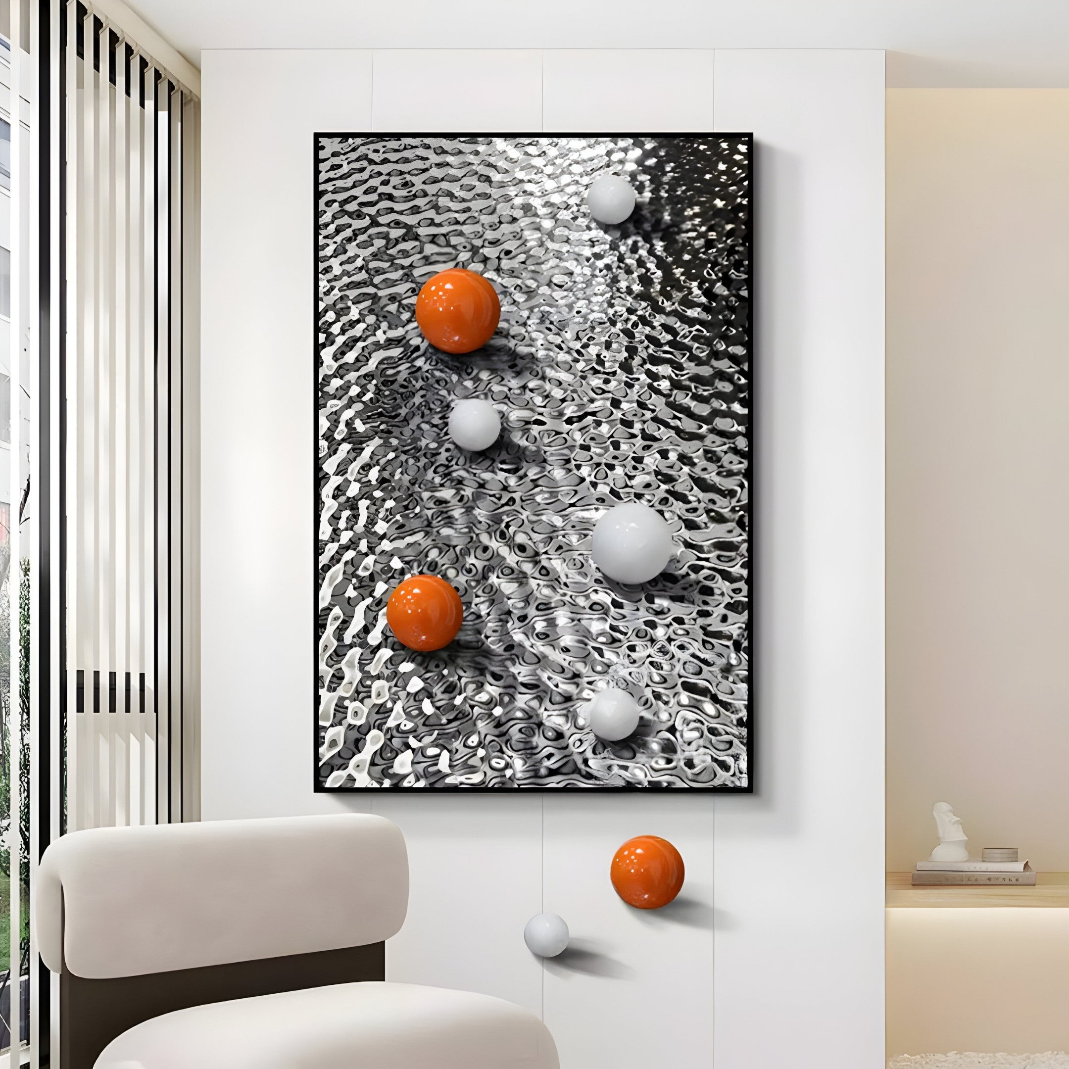 In a contemporary room, Giant Sculptures Luminosa Orange & White Orb Textured Metal Wall Art, with its black and white wavy background and orange spheres, effortlessly enhances the space alongside a chair in the foreground.