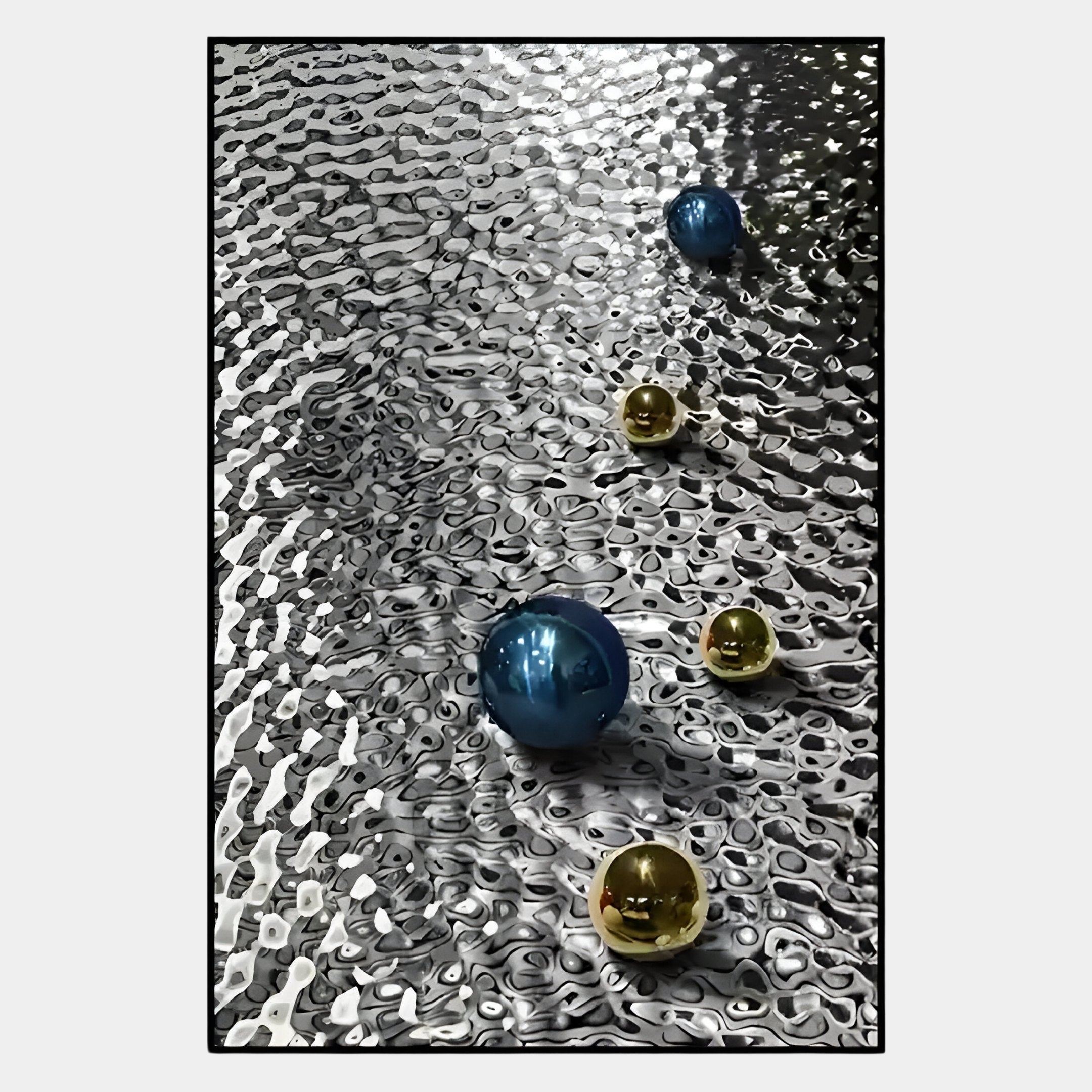 Luminosa Blue & Gold Orb Textured Metal Wall Art by Giant Sculptures features shiny blue and gold spheres on a wavy, reflective surface—ideal for adding striking contrast to modern living spaces.
