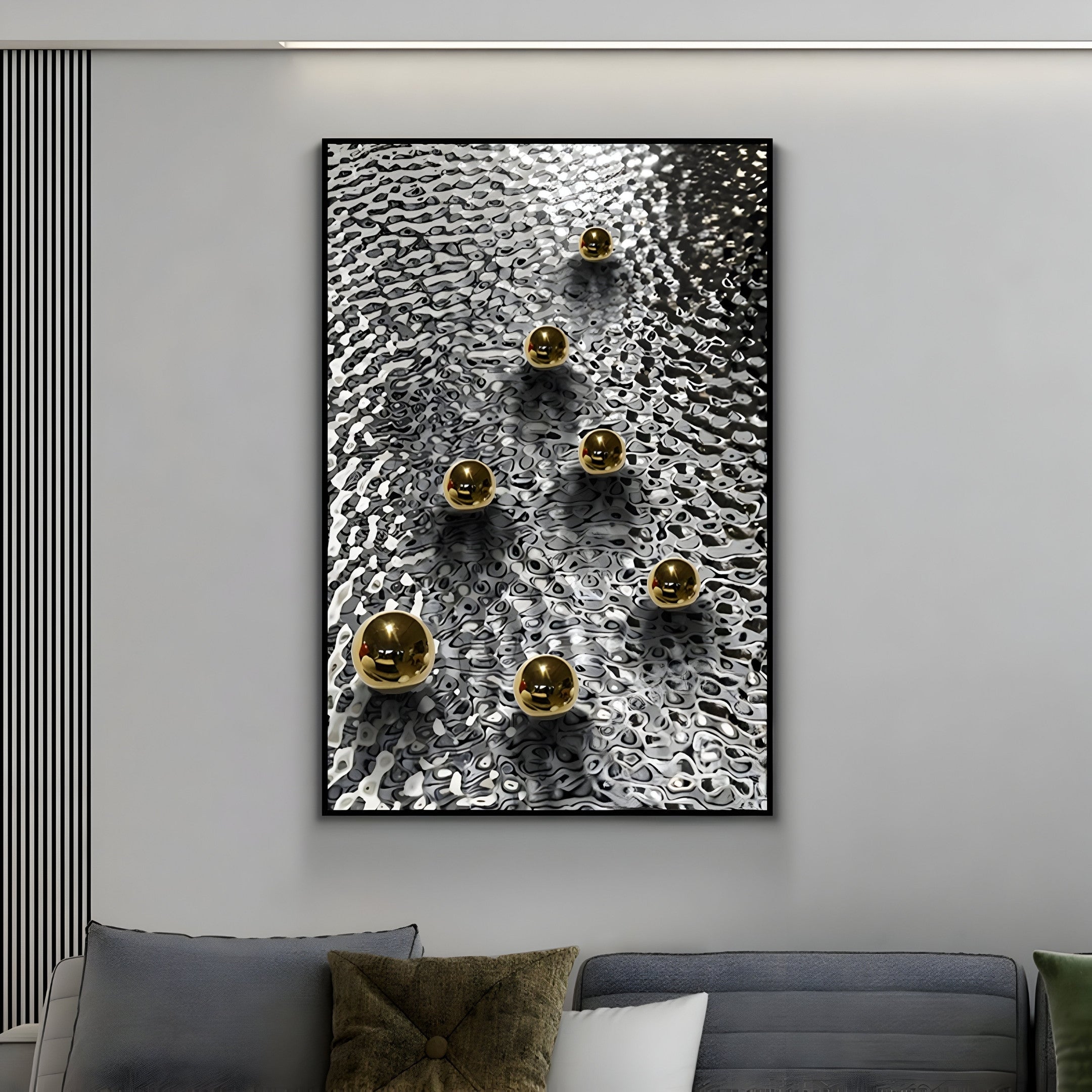 A modern living room highlights Giant Sculptures Luminosa Gold Orb Textured Metal Wall Art with nine spheres in a triangle on a textured black and white background, paired with a gray sofa and brown textured cushion for sleek design.