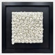 The Harmonia 3D Spiral Wall Sculpture by Giant Sculptures features numerous small, rolled spirals in textured white ceramic, arranged in a grid and displayed within a square black frame against a smooth black background.