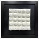 The Harmonia 3D Floral Grid Sculpture With Black Frame by Giant Sculptures features a black-framed square grid of 16 white, pillow-like ceramic forms with central holes—an ideal modern accent for your interior.