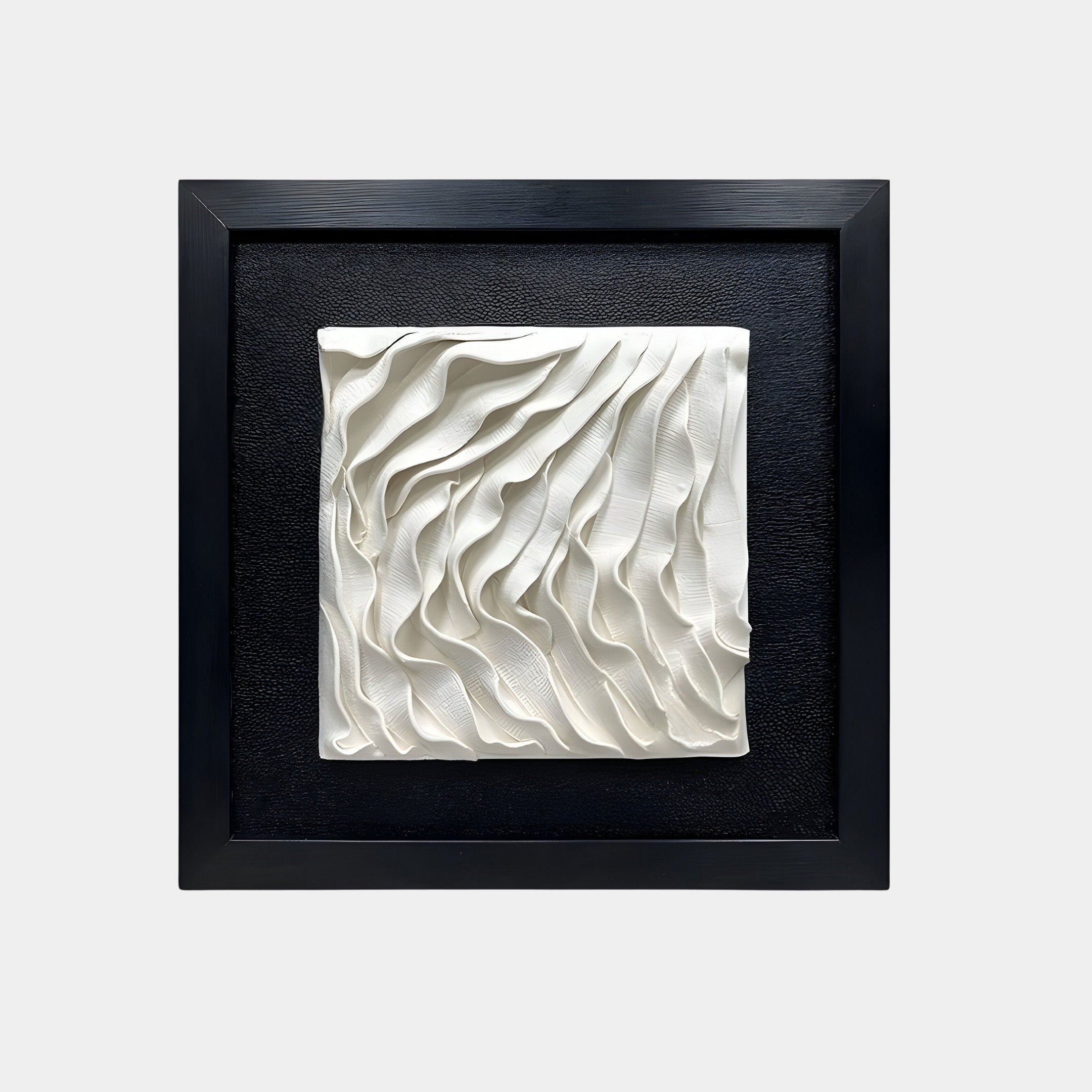 The Harmonia 3D Ceramic Wave Wall Installation by Giant Sculptures showcases an abstract, textured white sculptural piece on a black background. The simple black frame enhances the contrast, making it perfect for modern interiors.