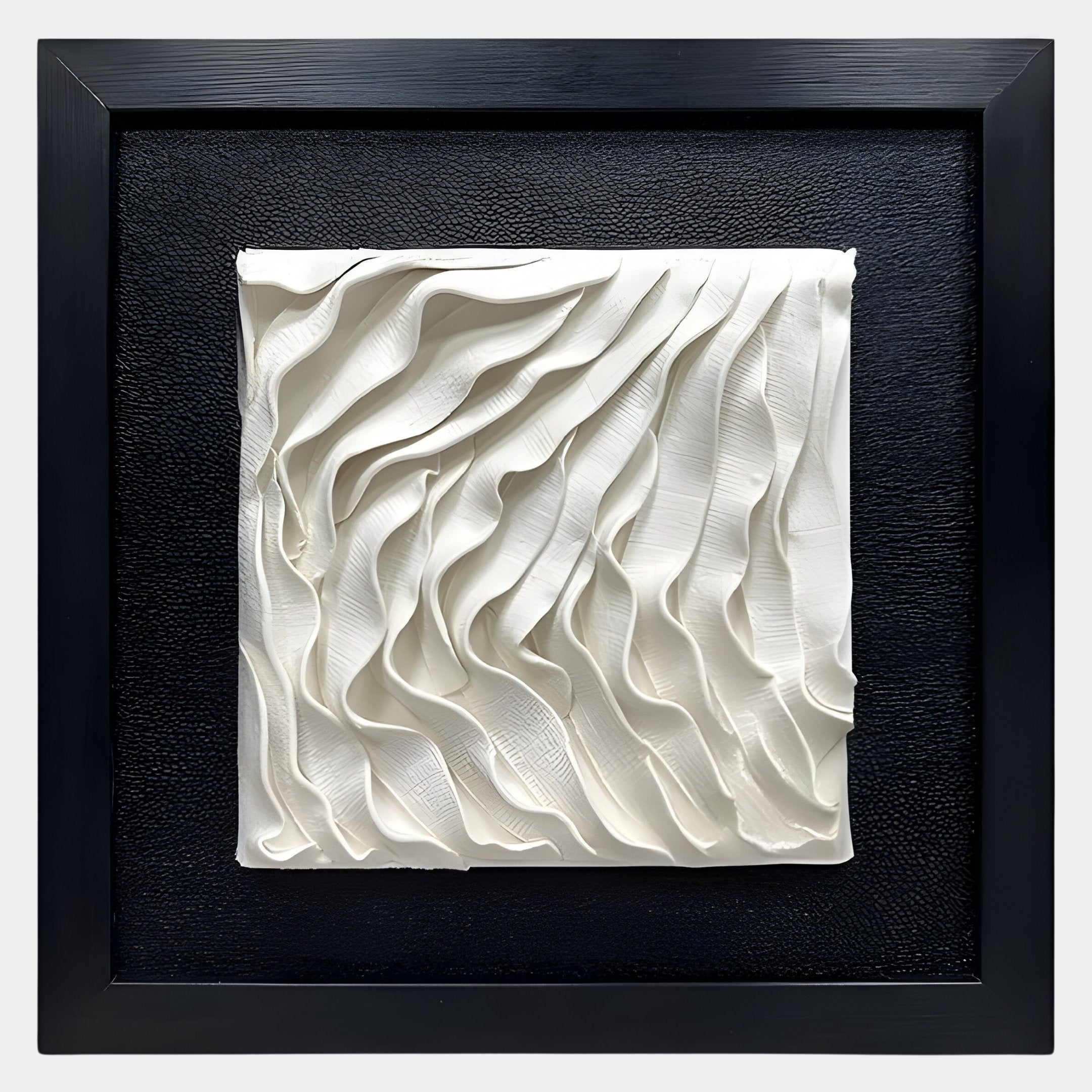 The Harmonia 3D Ceramic Wave Wall Sculpture by Giant Sculptures features flowing ridges on a textured white canvas, elegantly framed in black and mounted on a textured black background for striking wall art.