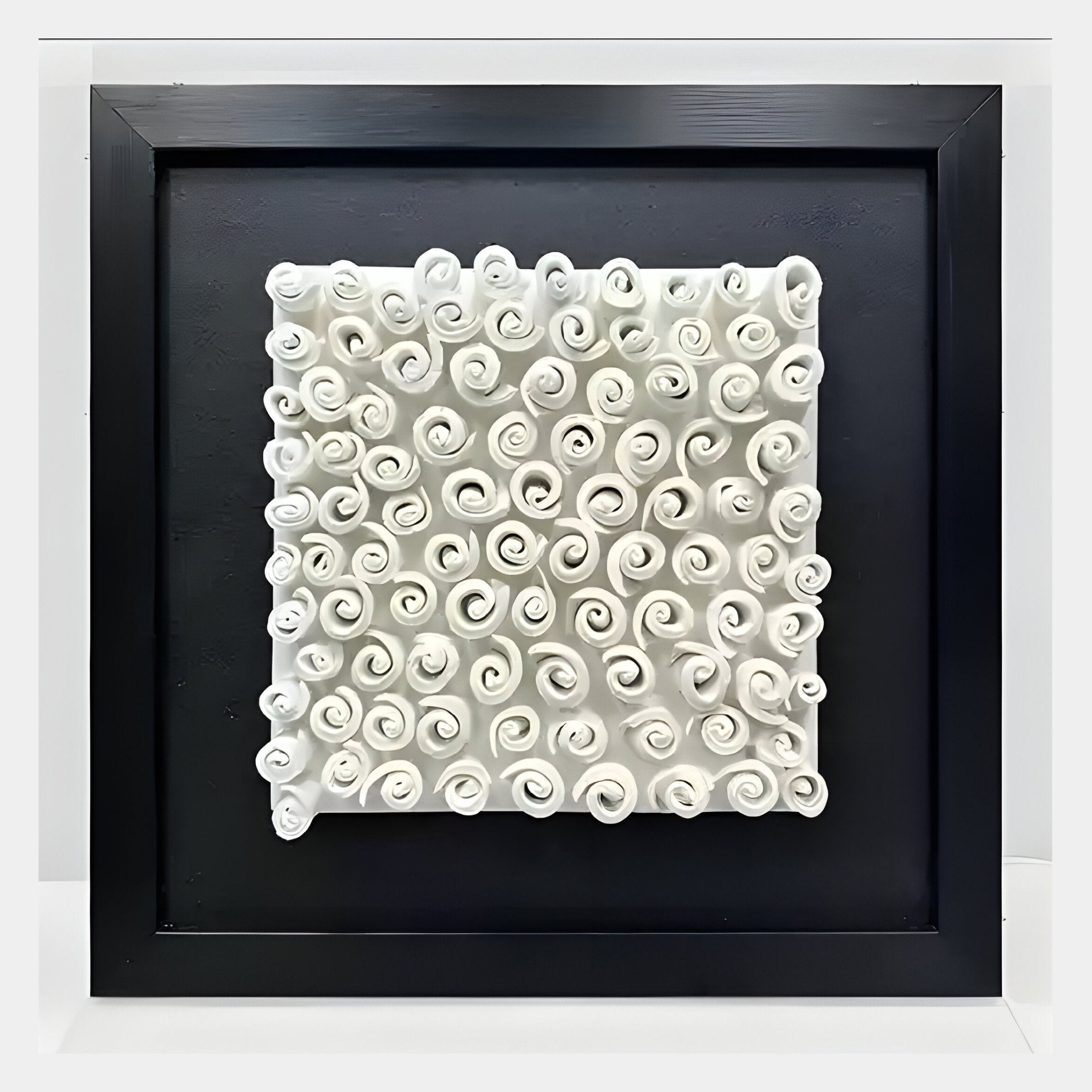 The Harmonia 3D Spiral Ceramic Wall Sculpture by Giant Sculptures features white, spiral ceramics in a square black frame with acrylic box—ideal for adding organic texture and modern style to contemporary interiors.