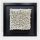 The Harmonia 3D Ceramic Grid Wall Sculpture by Giant Sculptures features white ceramic rods of varying lengths on a central square panel, set in a black frame and acrylic box—an eye-catching, modern wall art piece.