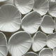 The Harmonia 3D Petal Wall Sculpture by Giant Sculptures showcases overlapping white ceramic petal shapes with textured surfaces, forming an abstract, floral-inspired design that exudes modern sophistication.