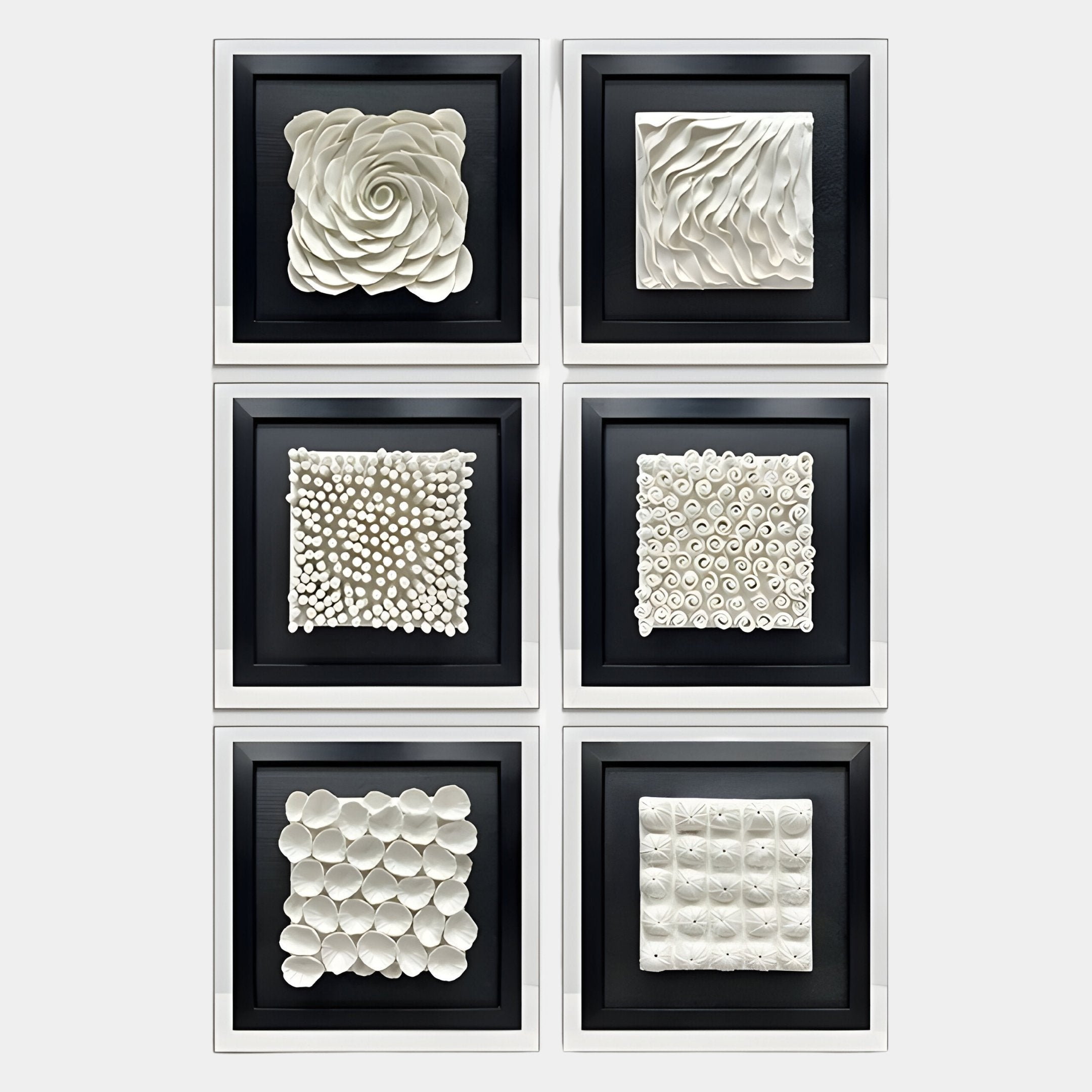 The Harmonia Set of 6 Ceramic 3D Wall Sculptures by Giant Sculptures features unique white textured designs—rose, waves, dots, spirals, petals, and geometric shapes—in black frames with acrylic boxes for a bold modern look.