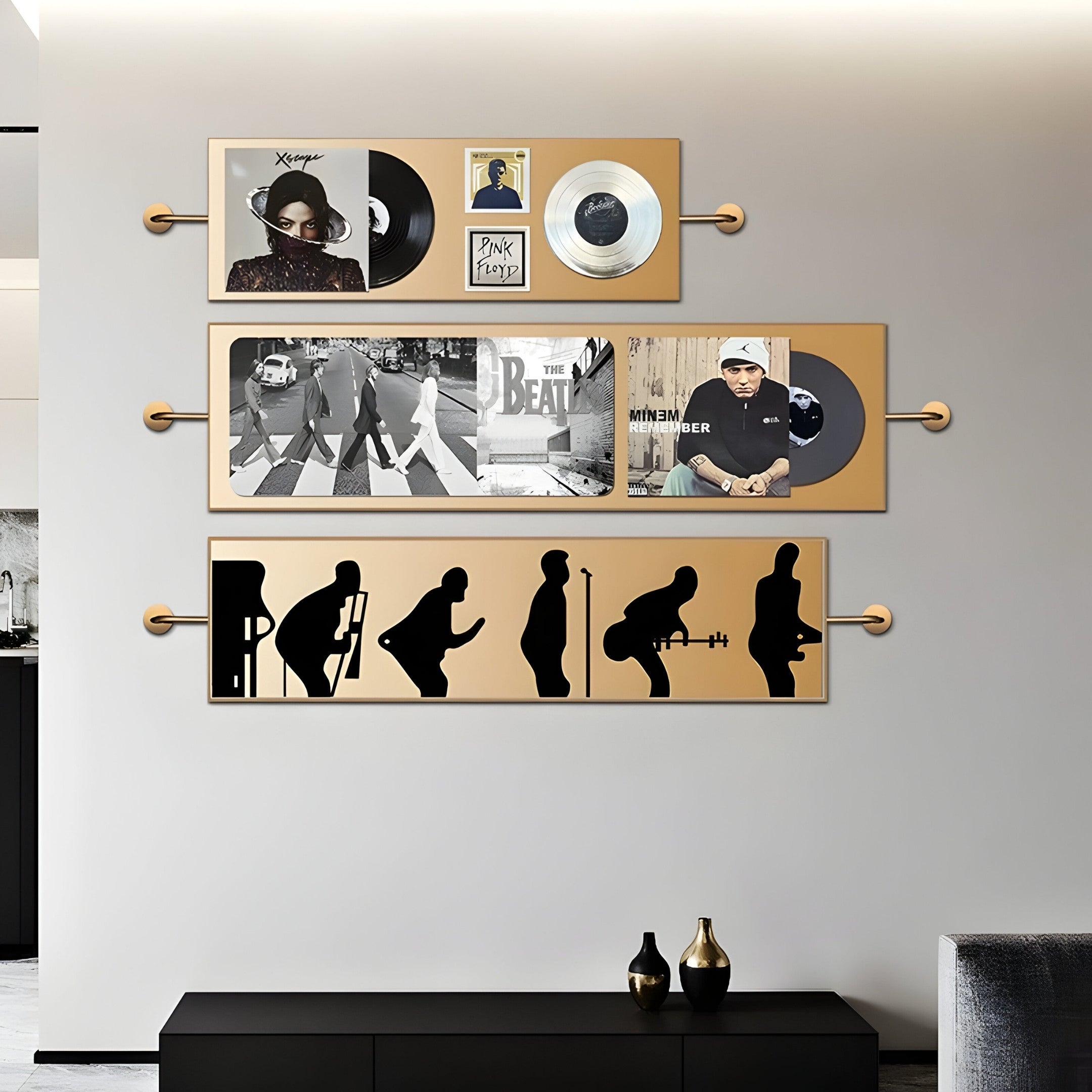 A modern living room wall features Giant Sculptures Resonance Multi-Panel Record & Silhouette Wall Art: record covers with a singers photo, a street crossing scene, and abstract performer silhouettes. A sideboard and soft lighting complete the decor.