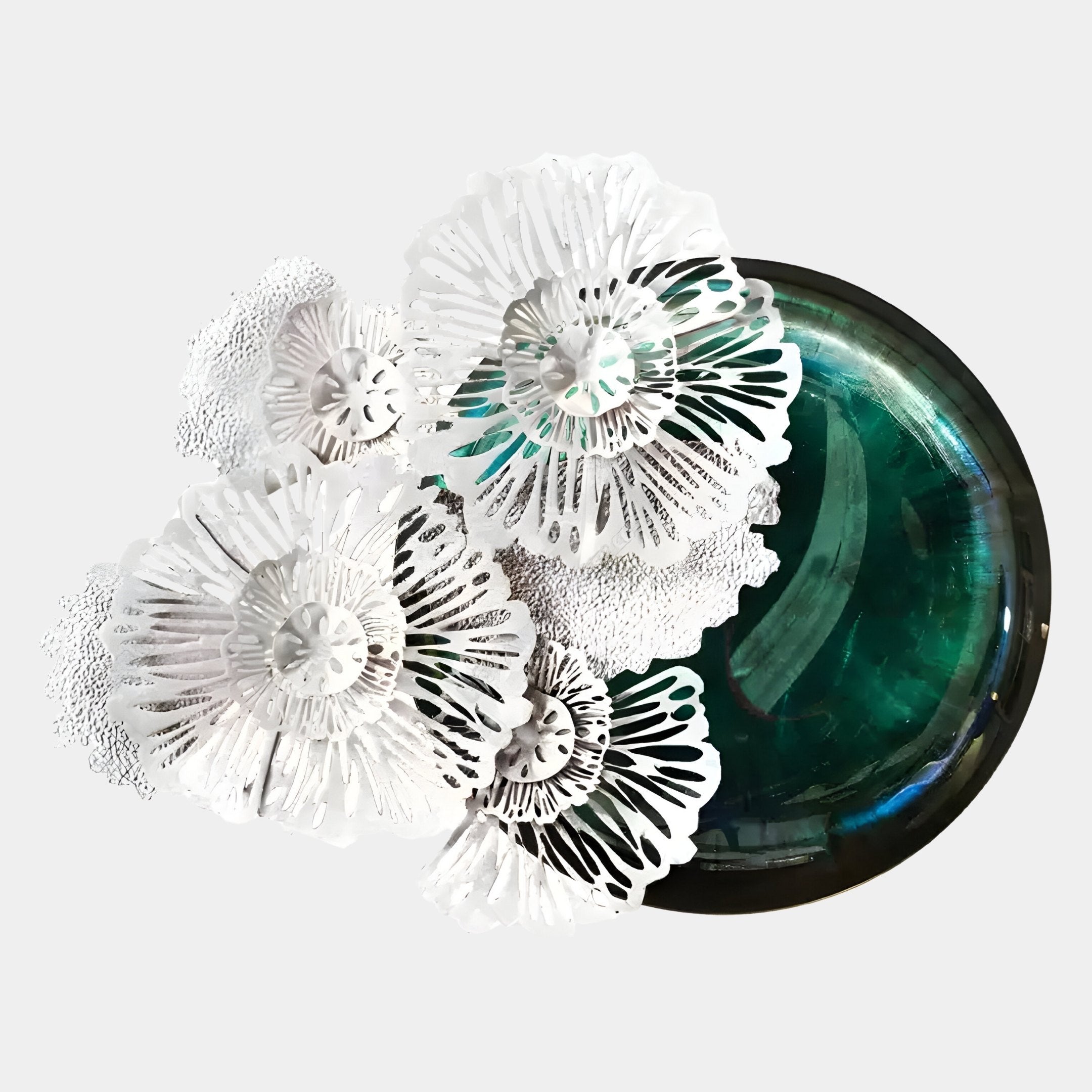 Aurum Flora White Petals Jade Metal Wall Art by Giant Sculptures features a circular green glass form with intricate white, lacy flower-like paper cutouts overlapping on the left, set against a plain light gray background.