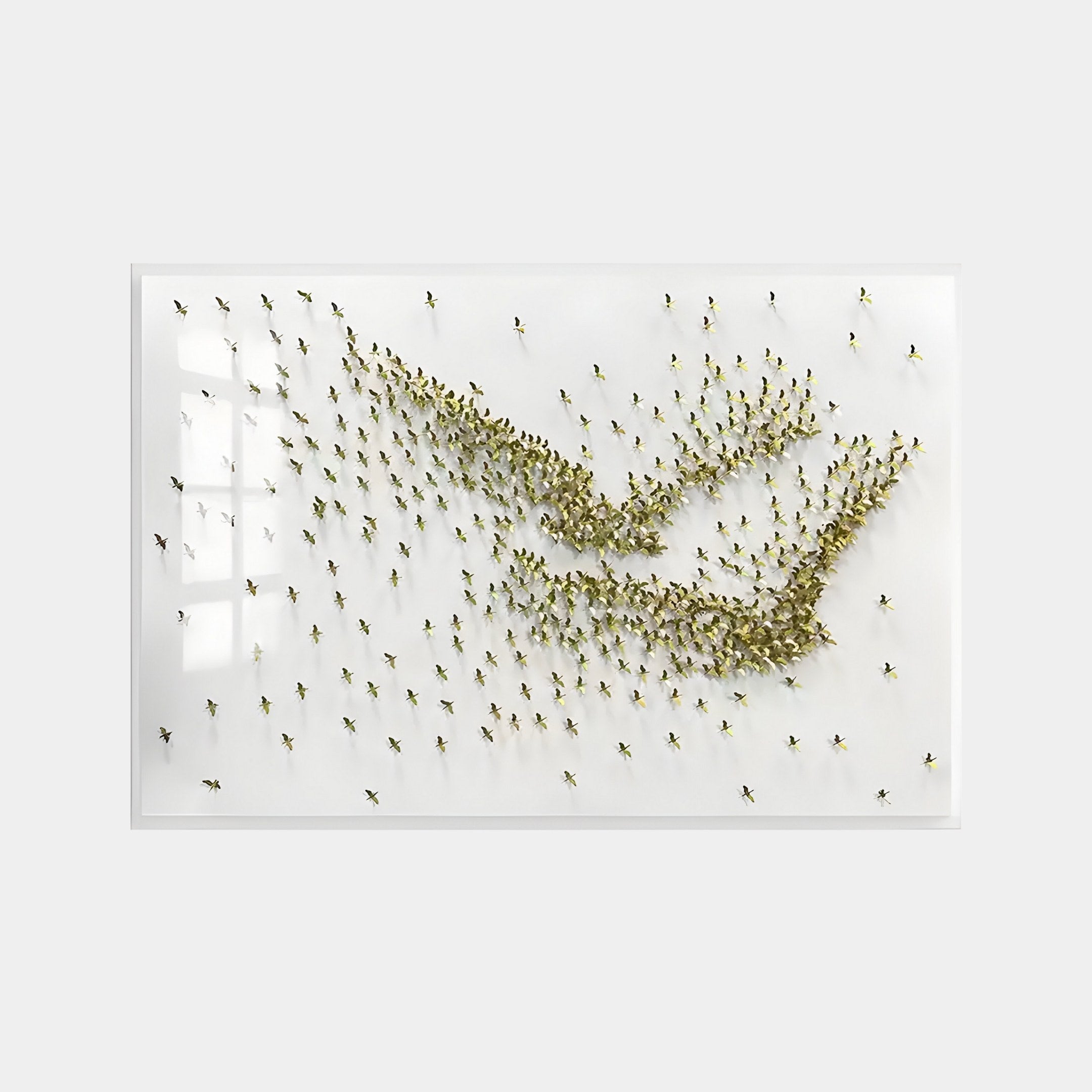 The Flock Golden Flight Sculpture Metal 3D Wall Art by Giant Sculptures is a minimalist installation with many grasshoppers, forming abstract wave or arrow shapes in a glass case against a white background.