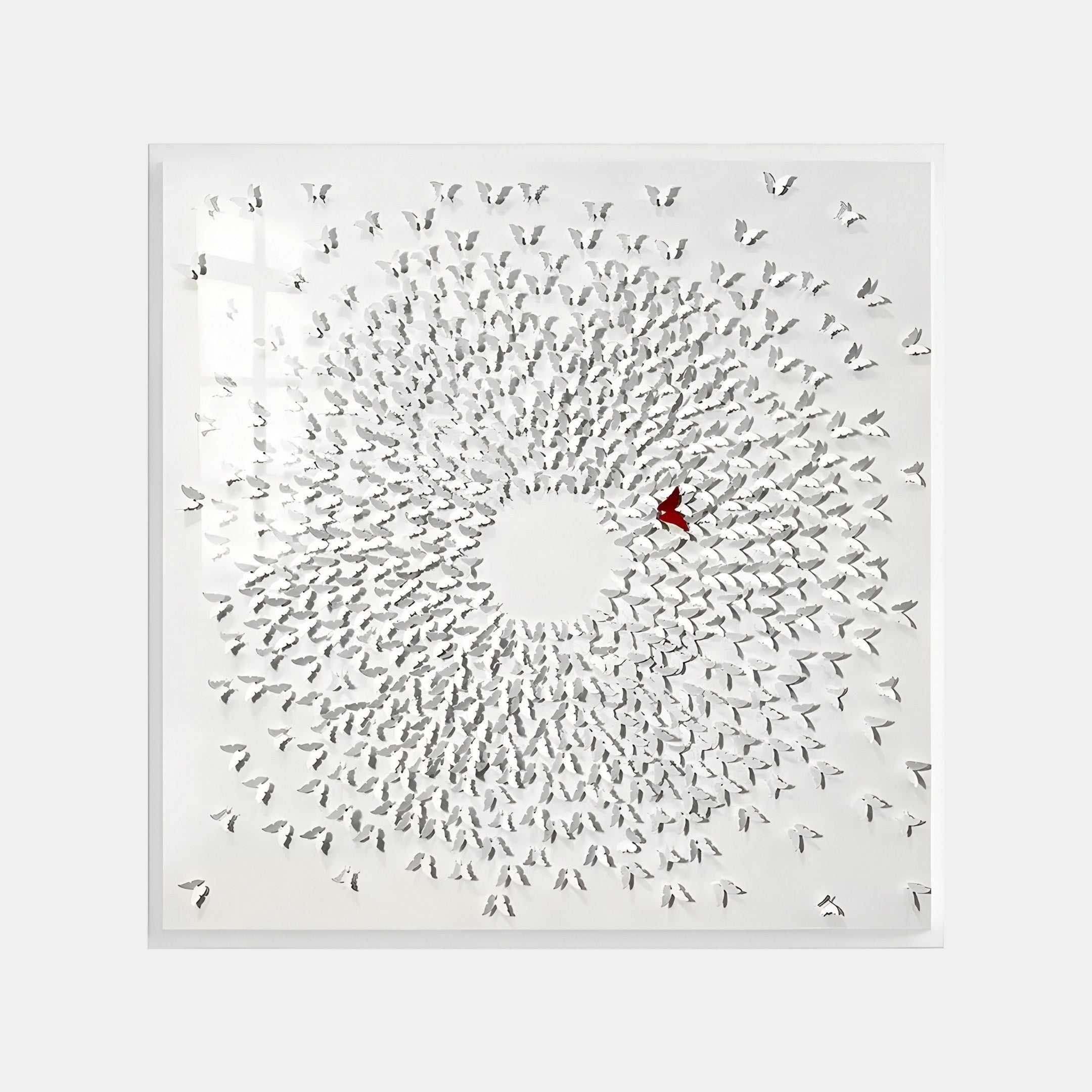 The Aviara Unity Circle Butterfly Sculpture by Giant Sculptures is a 3D metal wall art with a spiral of small white bird-like shapes and a standout red bird at the center, set against a white background for modern elegance and striking visual effect.