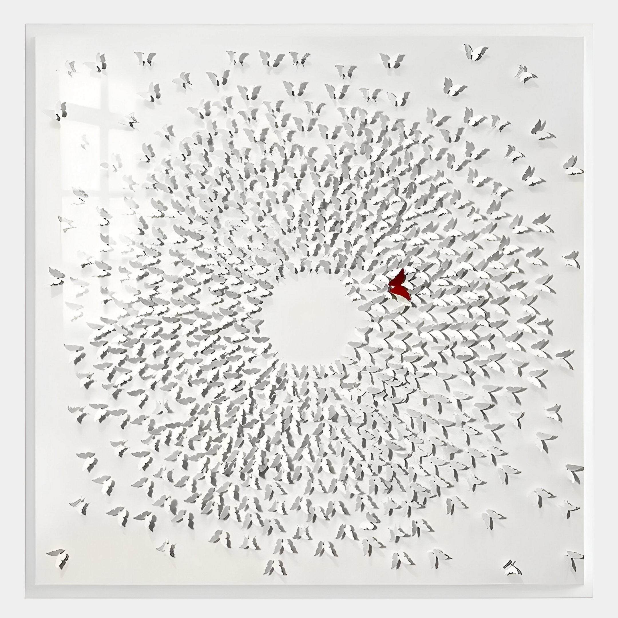The Aviara Unity Circle Butterfly Sculpture by Giant Sculptures is a modern 3D metal wall art featuring hundreds of white butterflies in a spiral, all outward-facing, with one striking red butterfly just right of center.