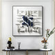 The Elysian 3D Ceramic Wall Art by Giant Sculptures in navy blue and white geometric design adorns the wall. Below, a console table displays a gold figurine, stacked books, a reed diffuser, and a vase with flowers and foliage.