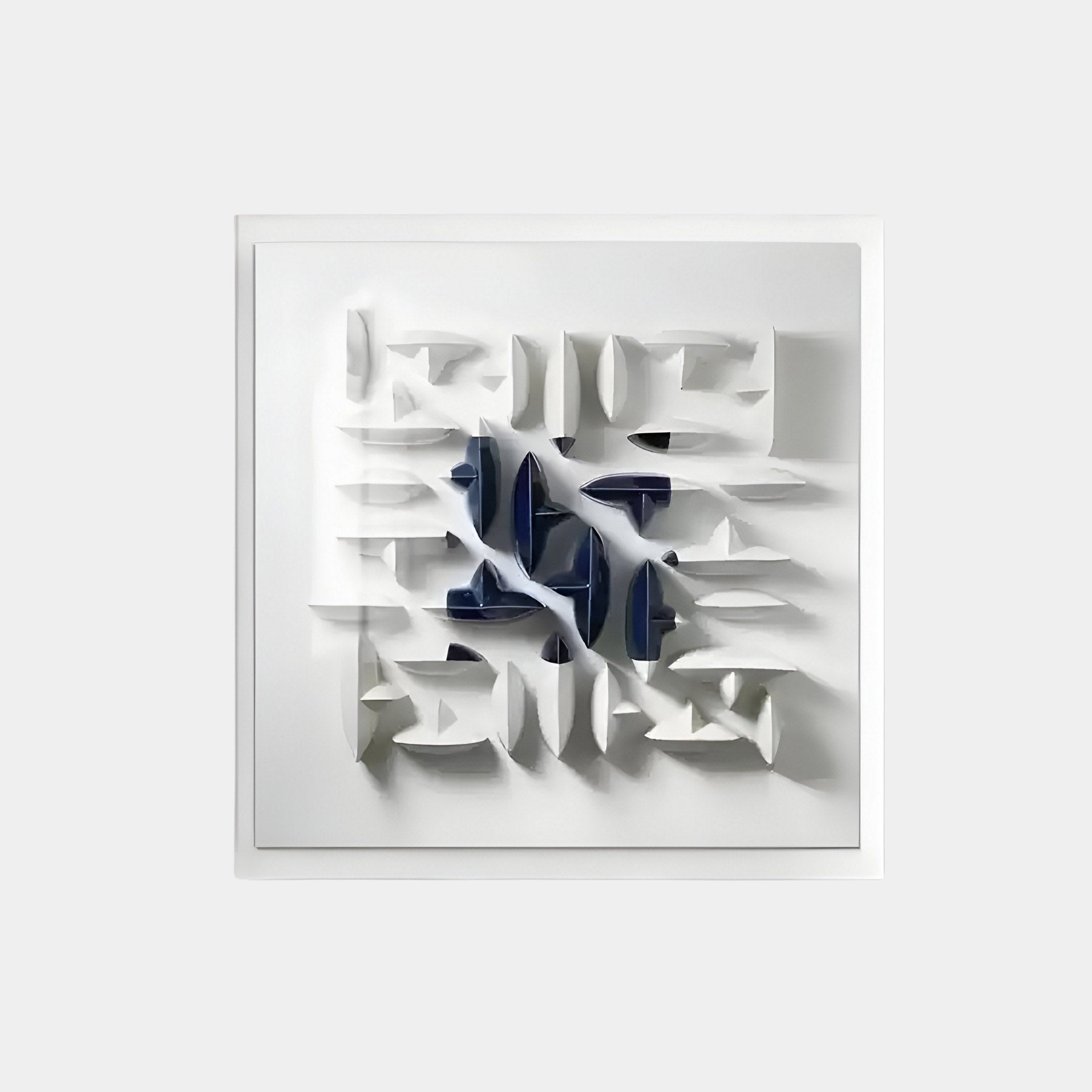 The Elysian 3D Ceramic Wall Art by Giant Sculptures features a white relief sculpture with abstract geometric shapes and cutouts in a symmetric pattern. Dark blue accents add contrast, creating depth, while subtle shadows enhance its standout presence in modern statement wall decor.