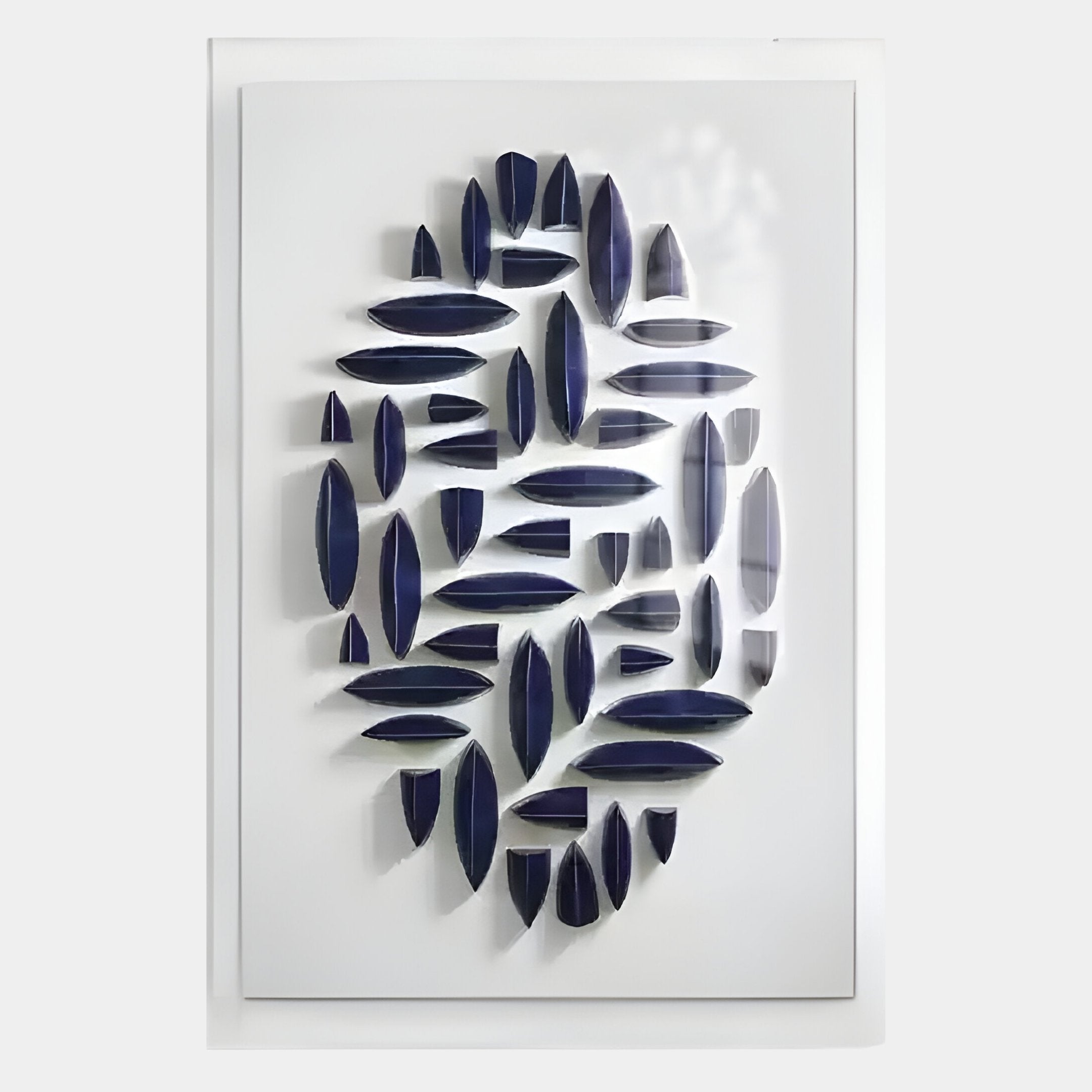 The Elysian 3D Ceramic Wall Art in Rhythmic Navy Blue by Giant Sculptures features white-framed ceramic ovals and elongated shapes in a dynamic cluster, perfect for adding depth and style to contemporary spaces.