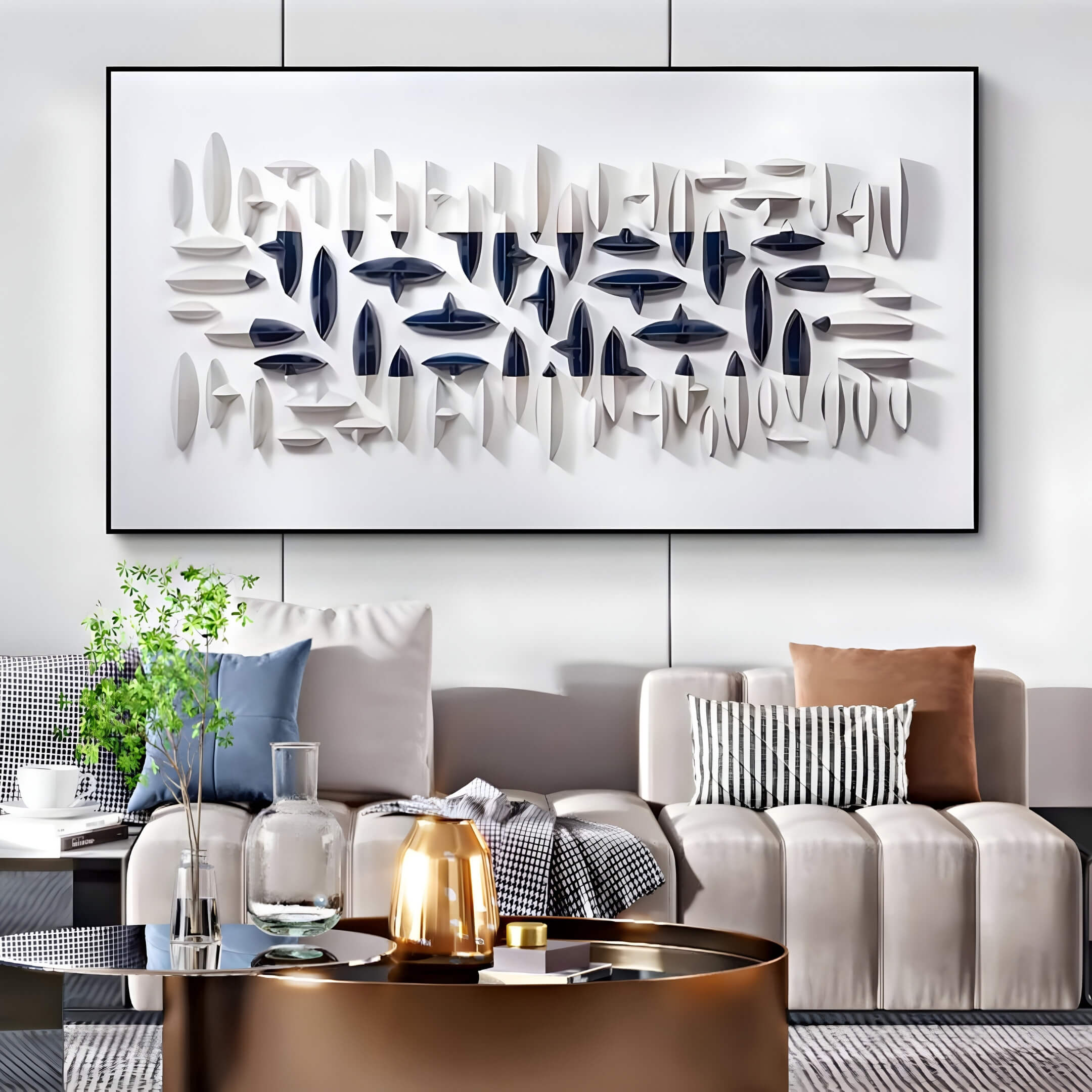 A modern living room with a minimalist design features a white couch, patterned throw pillows, and a round brass coffee table. The Elysian 3D Ceramic Wall Art by Giant Sculptures adds depth with its layered design, while ceramic forms adorn the table alongside a small plant.