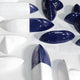 The Elysian 3D Ceramic Wall Art from Giant Sculptures features glossy ceramic shapes in abstract navy blue and white halves, lying on a textured white surface. Their varied sizes and orientations make them an ideal visually striking pattern for contemporary interiors.