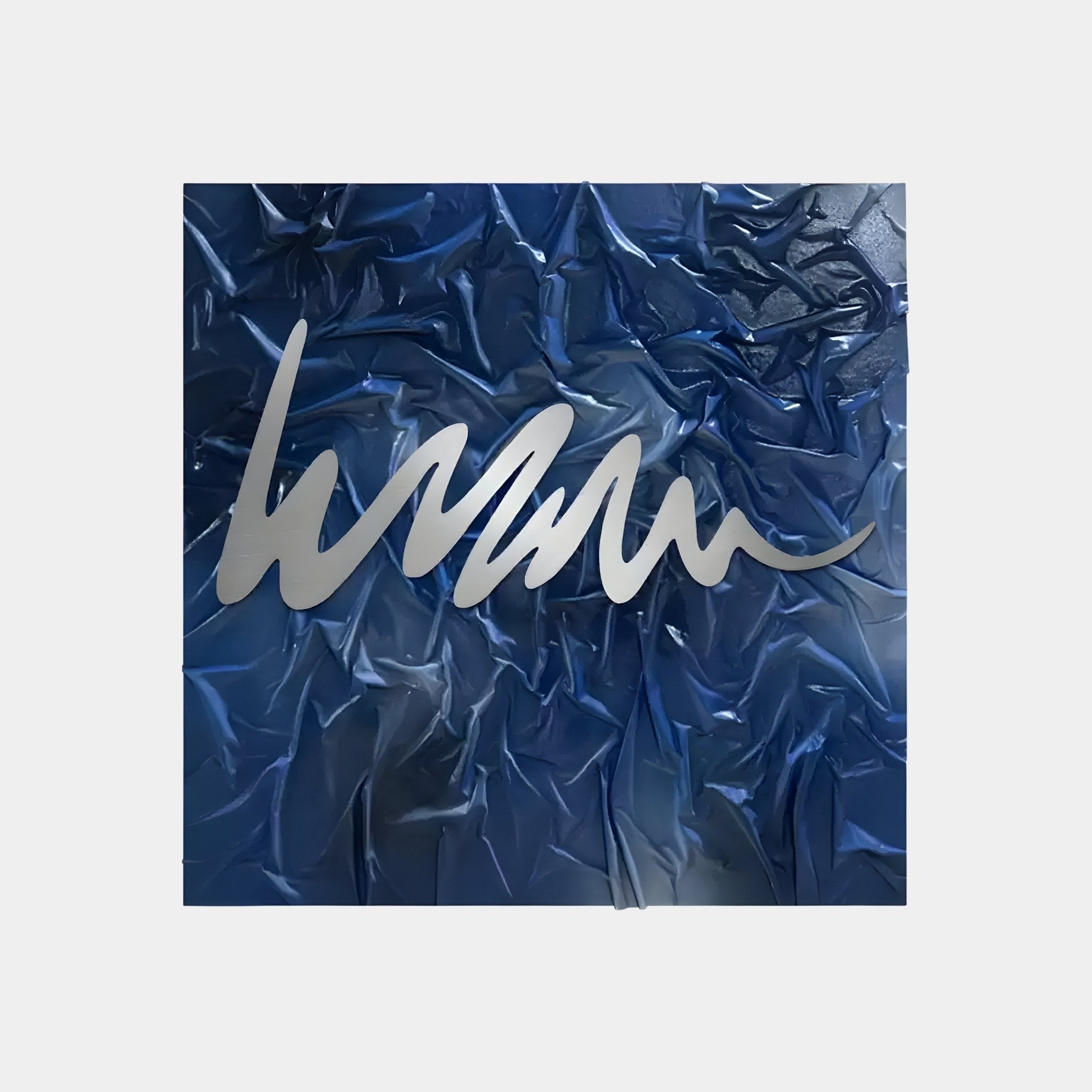 The Plisse Midnight Blue Textured Abstract Wall Art by Giant Sculptures showcases metallic silver waves on a textured background, offering a dynamic blend of curves and creases. Its the perfect modern aesthetic decor, adding an elegant touch to any space.