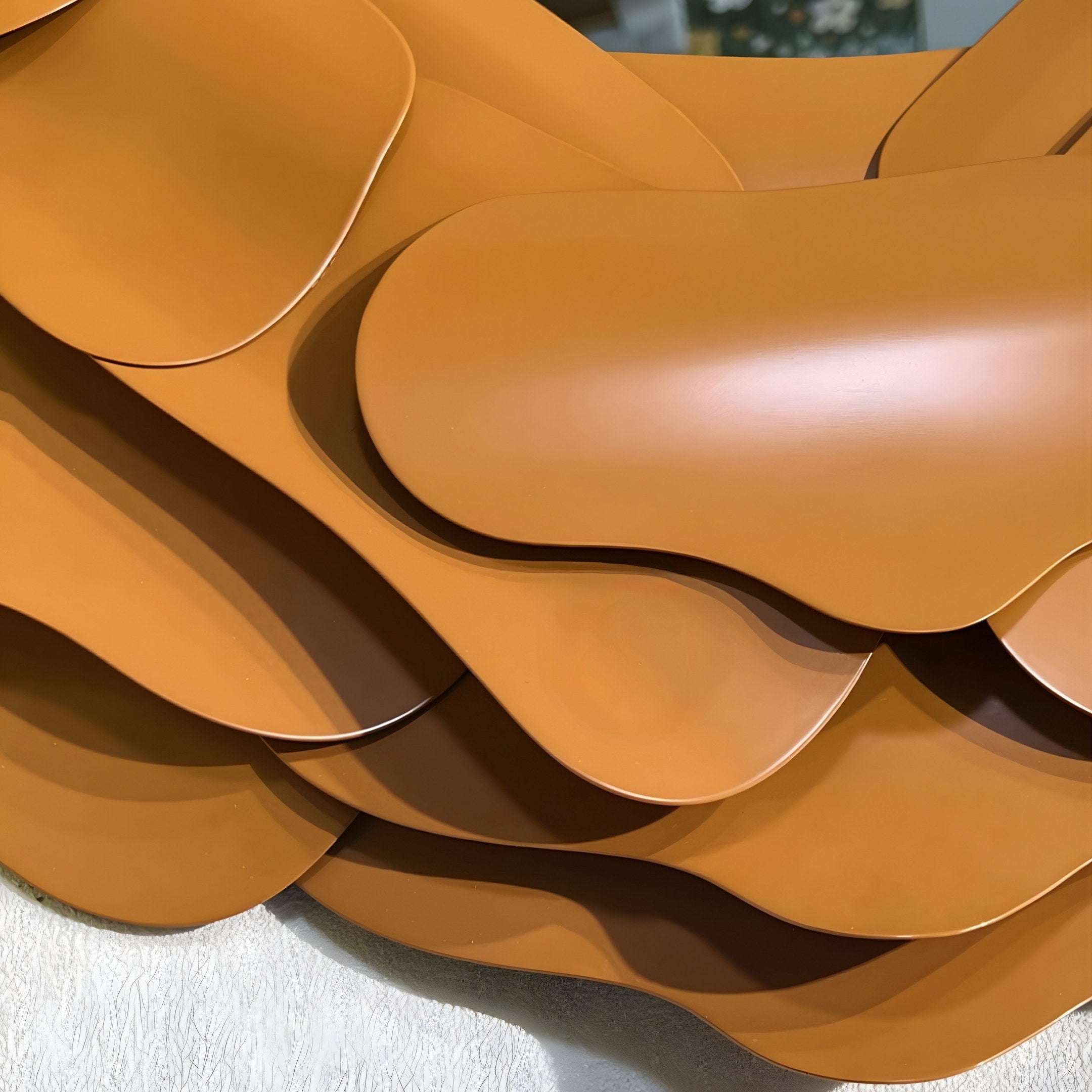 A close-up of layered, smooth brown sheets with rounded edges evokes Giant Sculptures Sculptura Mirror Warm Brown Floral Round Metal Wall Art.