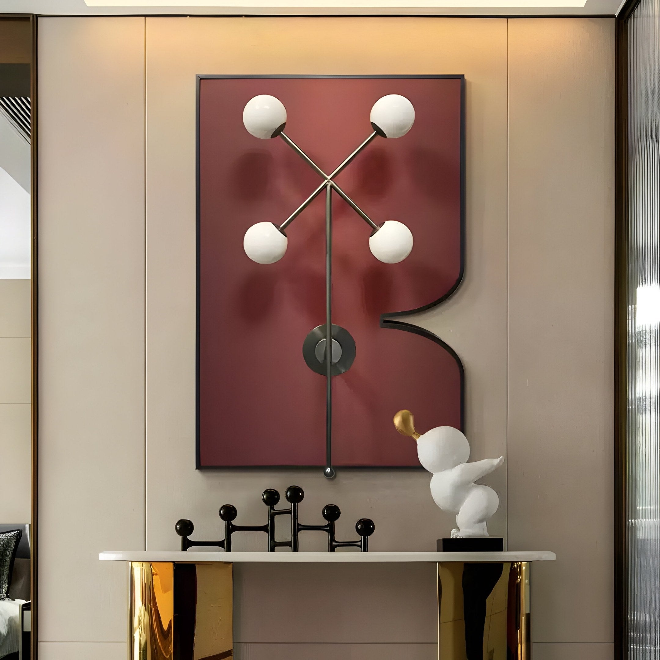 A modern interior features the Axial Elegance Burgundy Symmetrical Metal Wall Art by Giant Sculptures above a white console table. On the table, a small bird sculpture with gold accents showcases modern geometry at its finest.