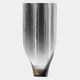 The Celestial Flow Waterfall Curved Vertical Abstract Metal Wall Art by Giant Sculptures features a sleek, reflective silver finish with waterfall-like streaks and a base revealing a contrasting brown layer—perfect for contemporary interiors.