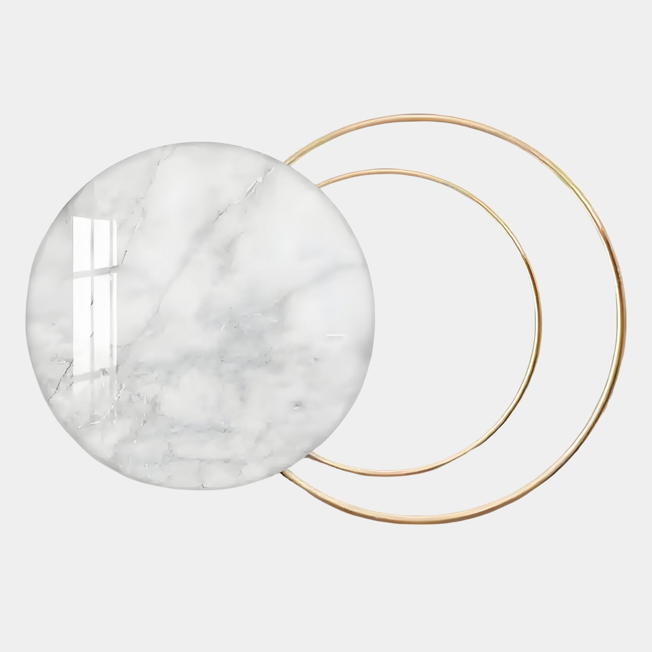 The Eclipse Luxe Bianco White Marble Circular Ring Wall Art by Giant Sculptures features round, white marble with subtle gray veins overlapping golden rings, reflecting light for a soft, modern, minimalist look.