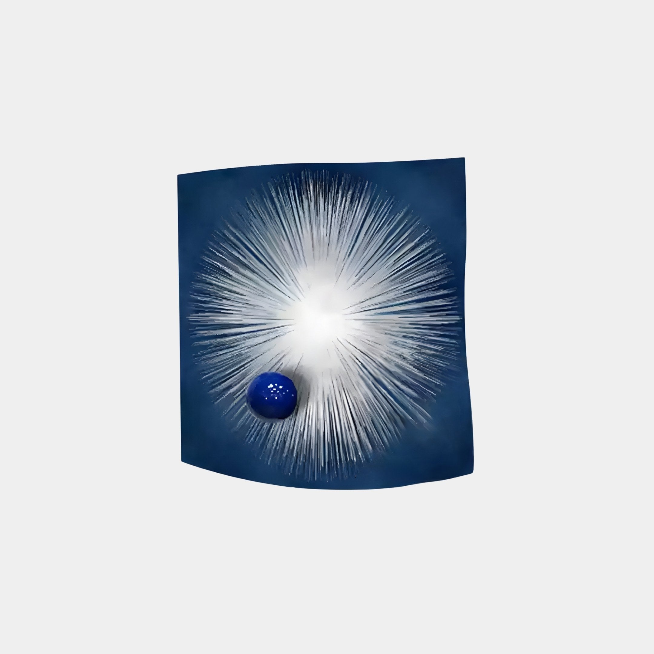 The Astralis Stellar Burst Abstract 3D Wall Art by Giant Sculptures showcases a blue and white starburst pattern with a large central light on a dark blue background, featuring a smaller solid blue sphere near the bottom left for a modern space-themed design.