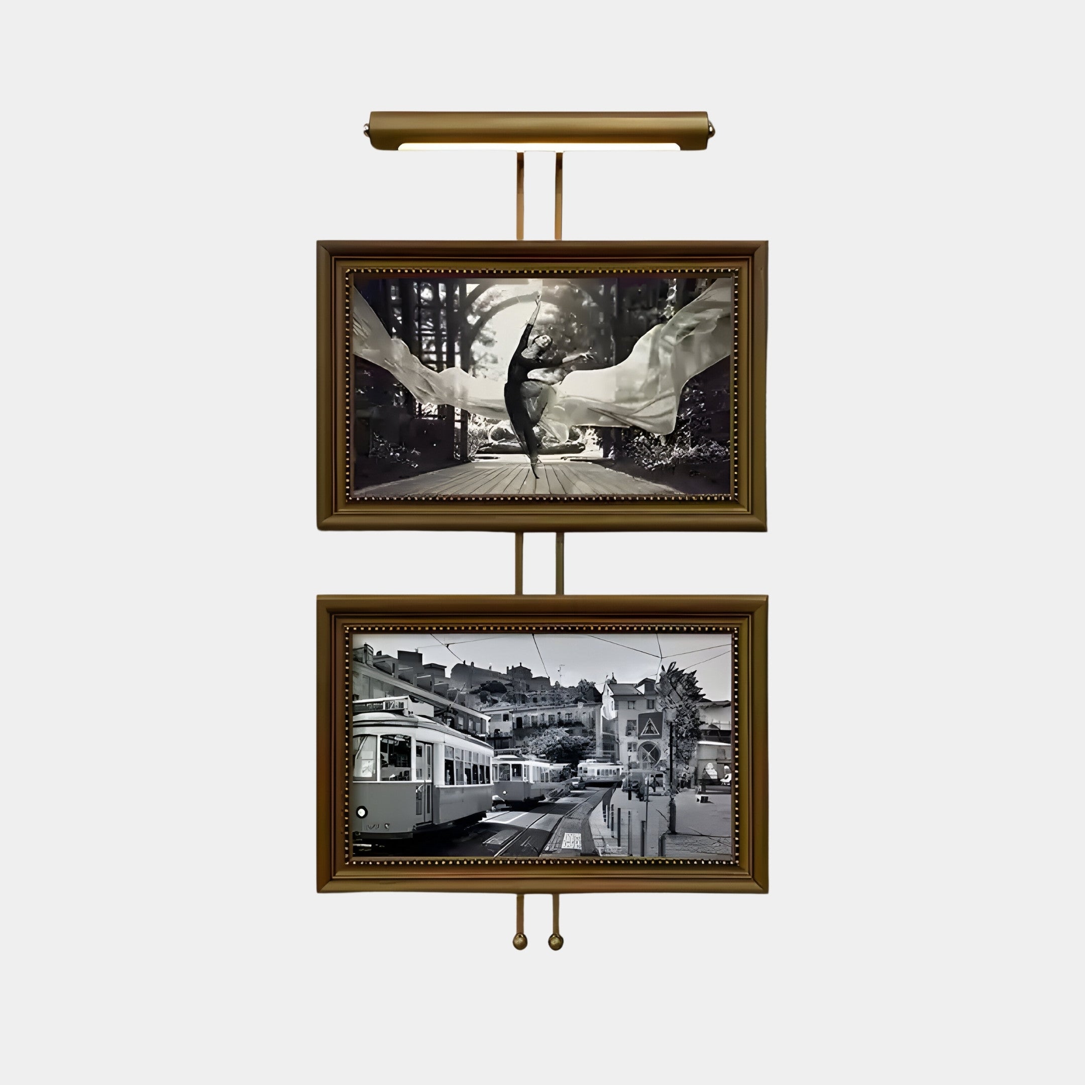 The Artisera Ballet Noir Luxe Dual Frame by Giant Sculptures features two photos: a dancer in flowing fabric on top and a vintage street scene with a tram below. The ornate golden finish and built-in light highlight the artistry, adding timeless elegance to any wall.