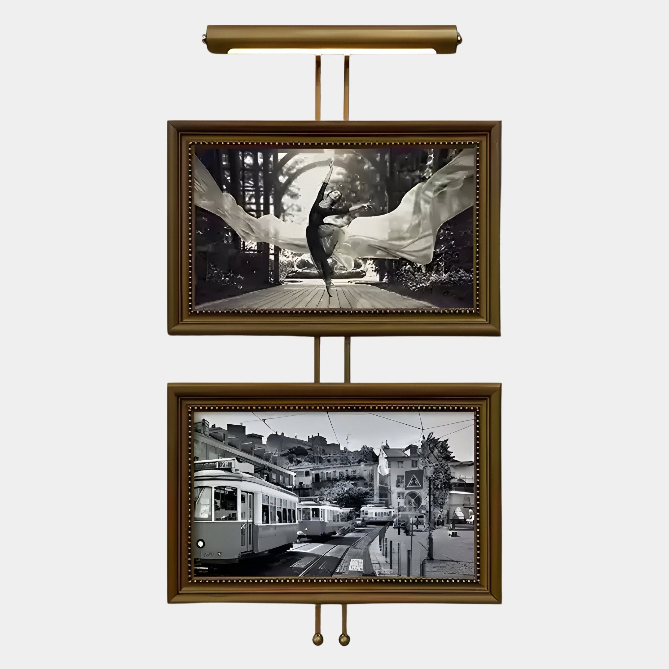 The Artisera Ballet Noir Luxe Dual Frame Built-In Light Wall Art by Giant Sculptures features two stacked black-and-white prints—a dancer with flowing fabric above a tram street scene—with an integrated gold light for a timeless look.