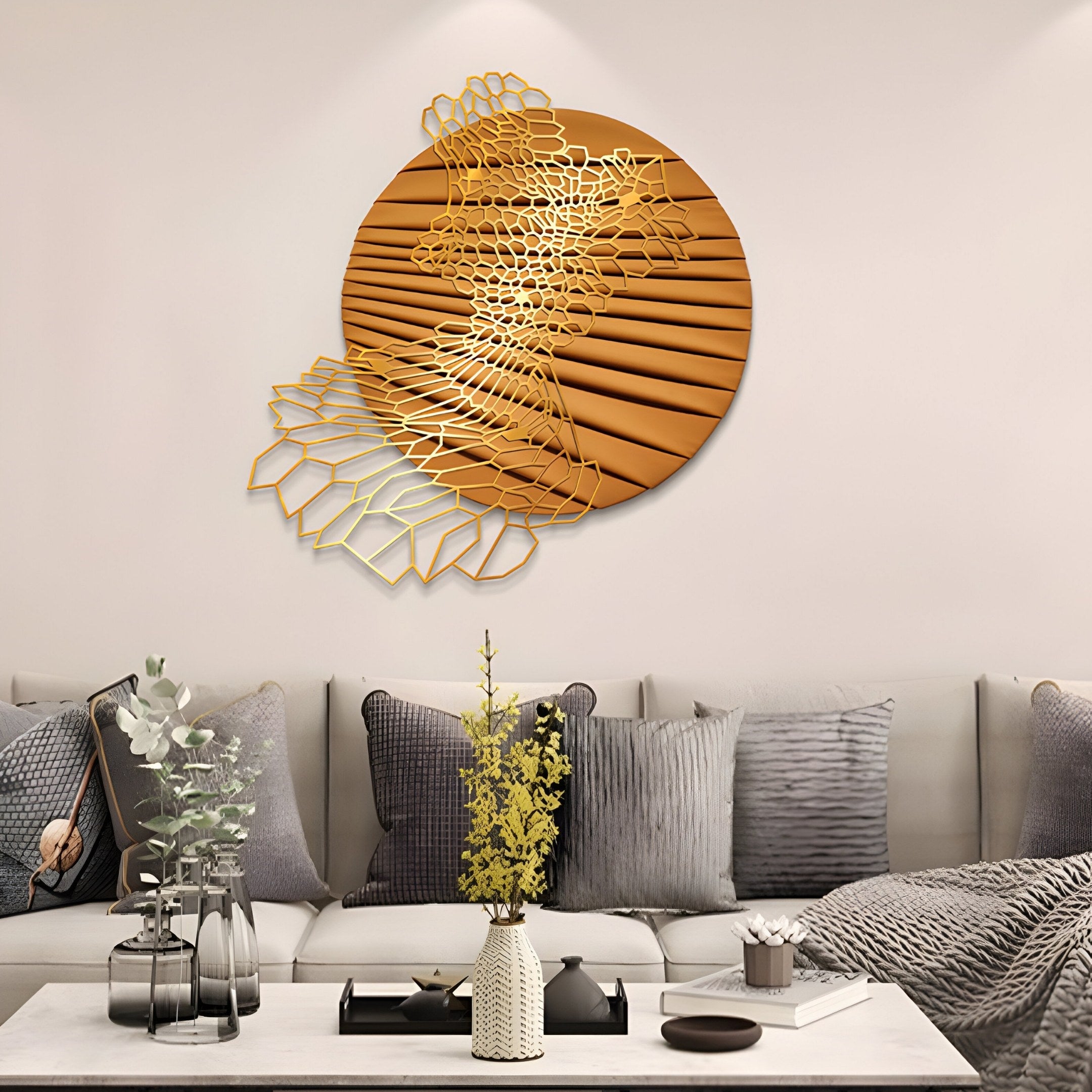 A modern living room showcases contemporary home decor with gray sofa cushions and Giant Sculptures Auramesh Sunset Orange-I Metal Winged Circular Geometric Wall Art. A coffee table features a vase of yellow flowers and a small plant, adding natural elegance to the sleek setup.