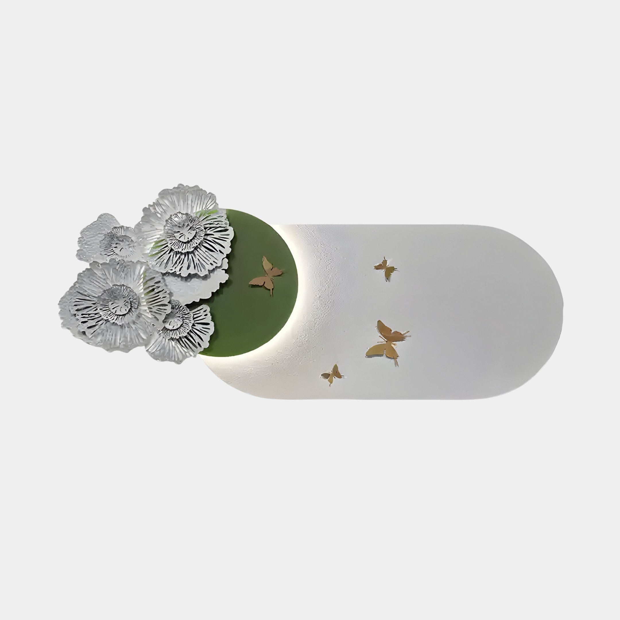 The Flutter Bloom Green Butterfly Floral 3D Wall Art by Giant Sculptures features intricate white flowers on a green circle, transitioning into an elongated white oval with golden butterflies. Its gently backlit against a plain white background, enhancing its elegant nature-inspired design.