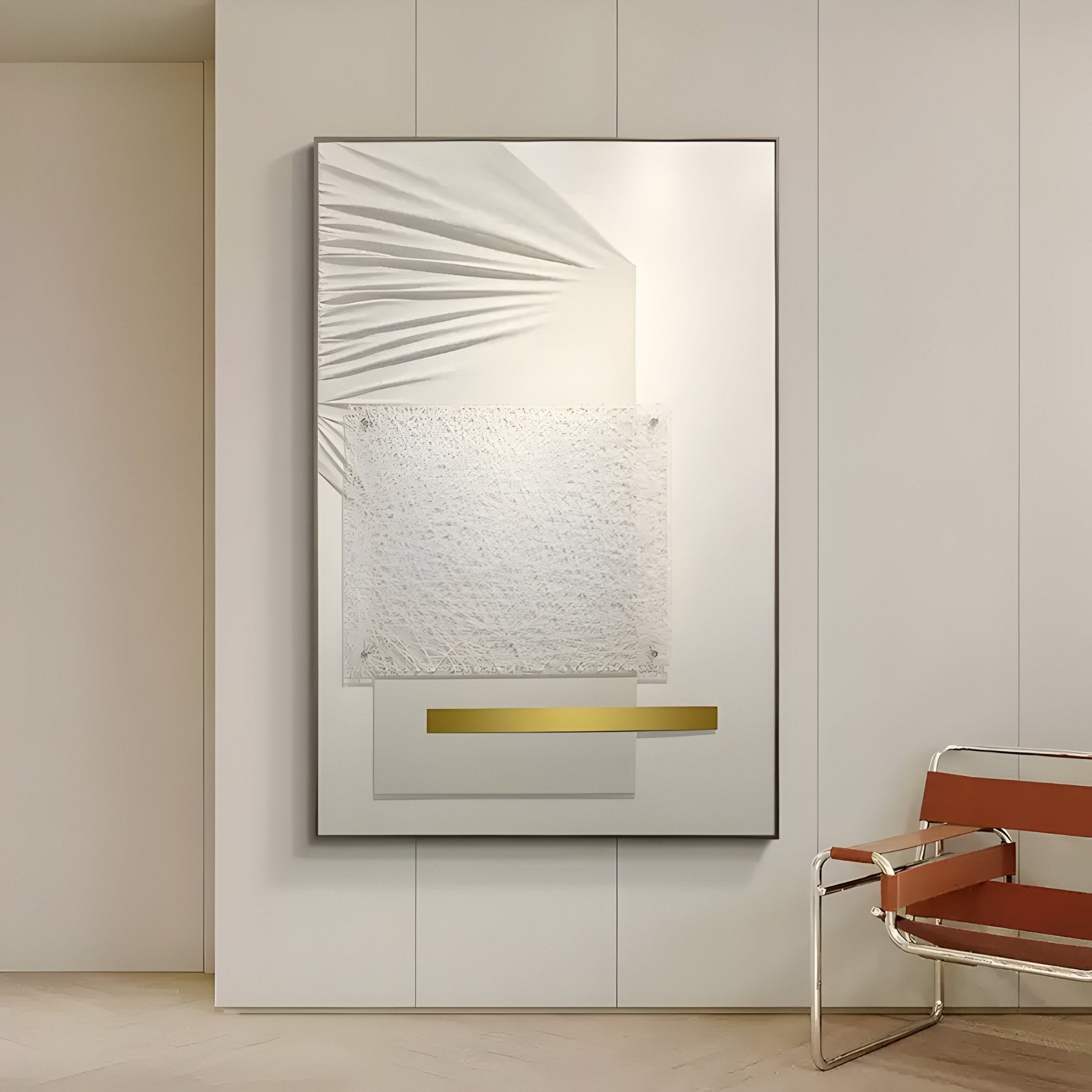 The Opus White & Gold Accent Clean Geometric Leather 3D Wall Art by Giant Sculptures, featuring white and gray geometric shapes with a gold accent line, elegantly hangs near a chair with brown leather seating and a metallic frame, perfectly complementing the minimalist setting.