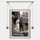 The Aristo Royal Wedding Painting Gold Frame Hanging Wall Art by Giant Sculptures depicts a medieval couple in elegant attire on stairs, surrounded by onlookers, medieval buildings, and rose petals—adding regal charm to your space.