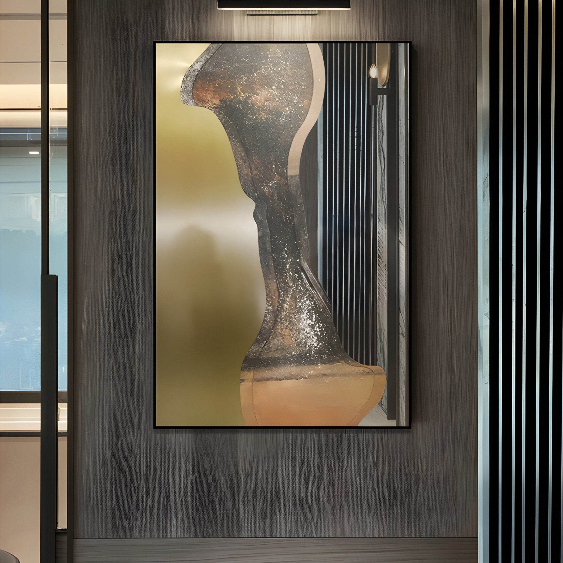 The Astrid Metallic Abstract Silhouette Wall Art from Giant Sculptures hangs on a dimly lit wall, showcasing modern craftsmanship with earthy colors, metallic gold tones, and green and beige textured patterns that create a smooth gradient transition.