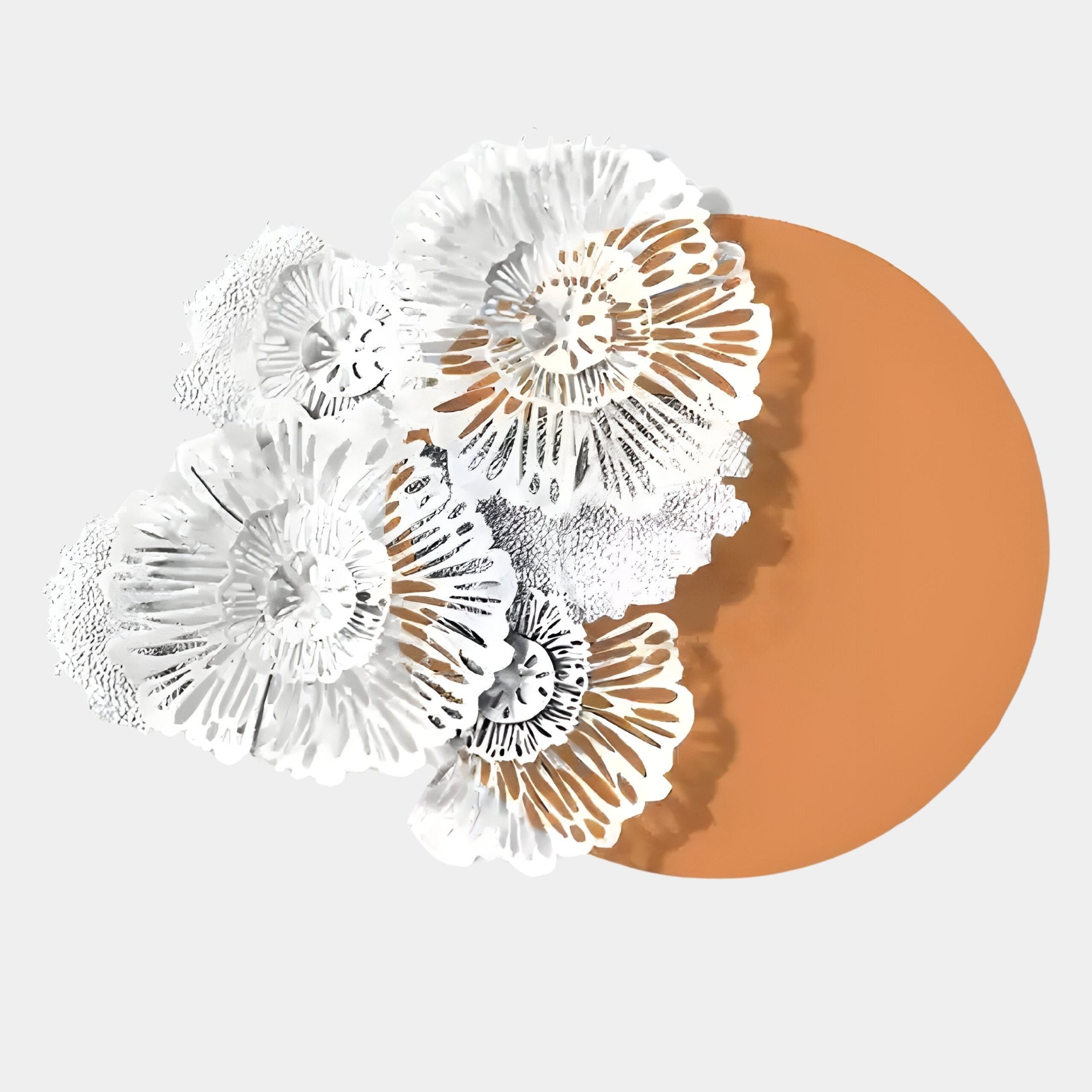 The Fleur Halo Terracotta Round White Metal Floral Decorative Wall Art by Giant Sculptures showcases intricate flowers casting delicate shadows on an orange circle, evoking nature-inspired decor against a light gray backdrop.