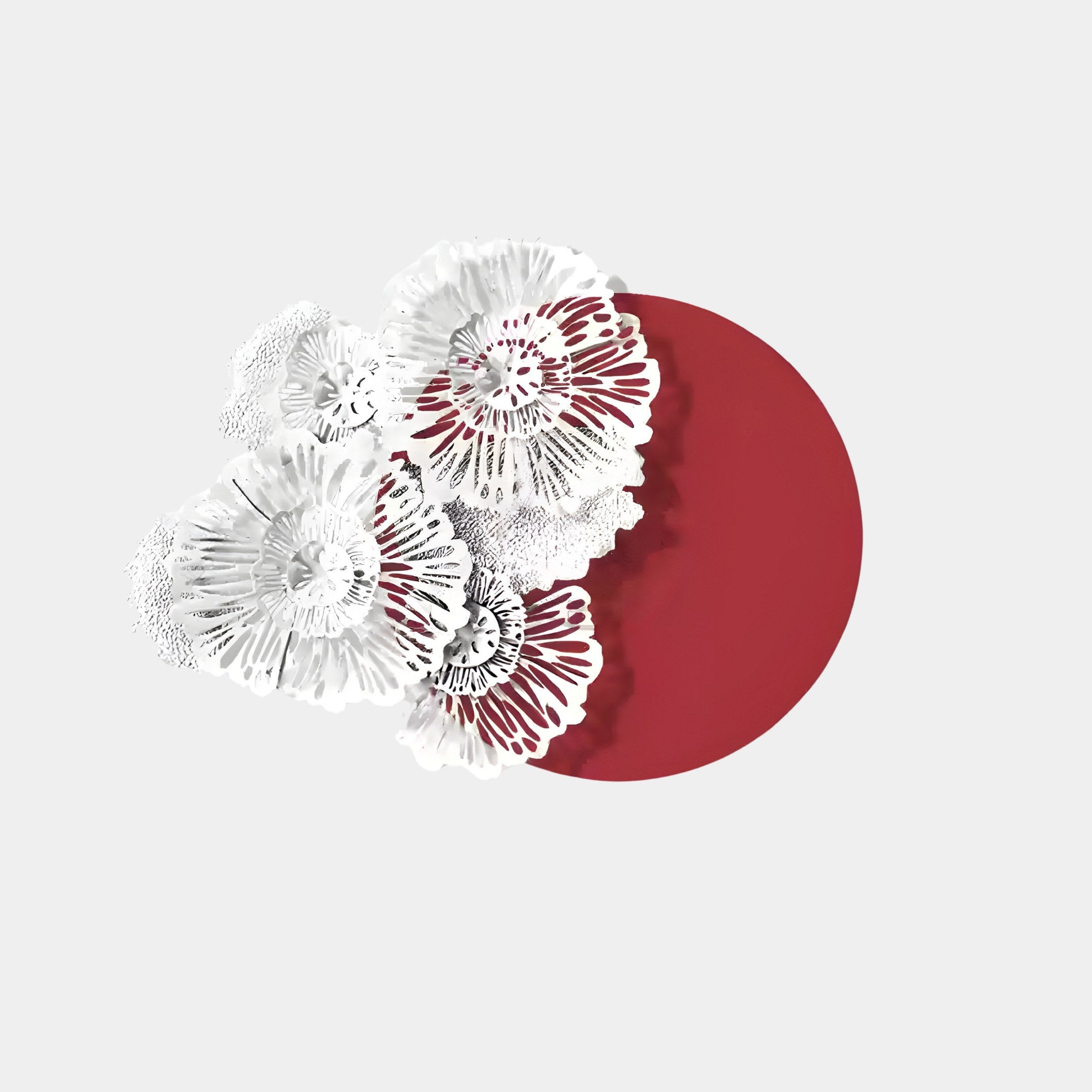 The Fleur Halo Red Round White Metal Floral Decorative Wall Art by Giant Sculptures features intricate lace-like white metal flowers on a bold red circle, set against a light gray background, emphasizing the detailed textures and delicate floral patterns.