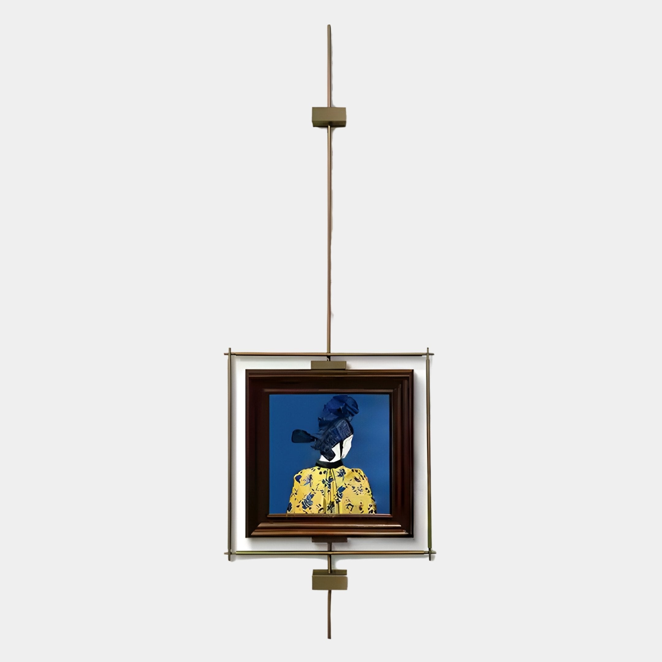 Ethereal Frames Regal Blue Portrait Suspended Wall Art by Giant Sculptures features a person in profile, dressed in yellow and blue, elegantly mounted on a vertical metal rod with brass fixtures against a plain light background.