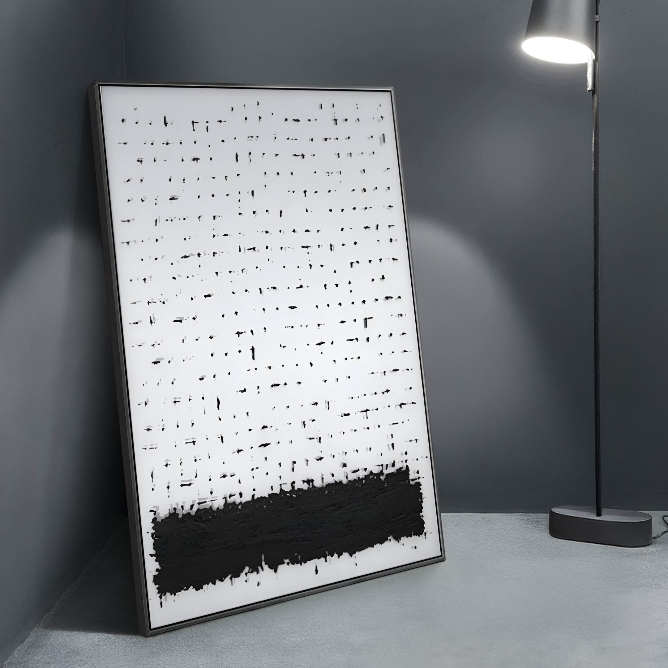 The Ethore Textured Minimalist Silk Art Panel by Giant Sculptures leans against a wall, displaying a white background with bold black vertical and horizontal marks, and a dense black area at the bottom. A modern floor lamp enhances the sophisticated ambiance on a sleek gray floor.