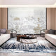 Elegant living room featuring a large Chinese landscape wall art with gold accents, complementing minimalist furniture and a marble coffee table.