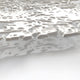 Macro view of silver embossed textures on a decorative wall panel, emphasizing artistic detail and refined finishes.