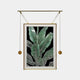 The Giant Sculptures Glacia Green Botanical Crystal Hanging Framed Wall Art features stylized green leaves with white outlines on a black background. It elegantly hangs in a unique gold frame with suspended rods and round weights on either side, offering a contemporary touch to any space.