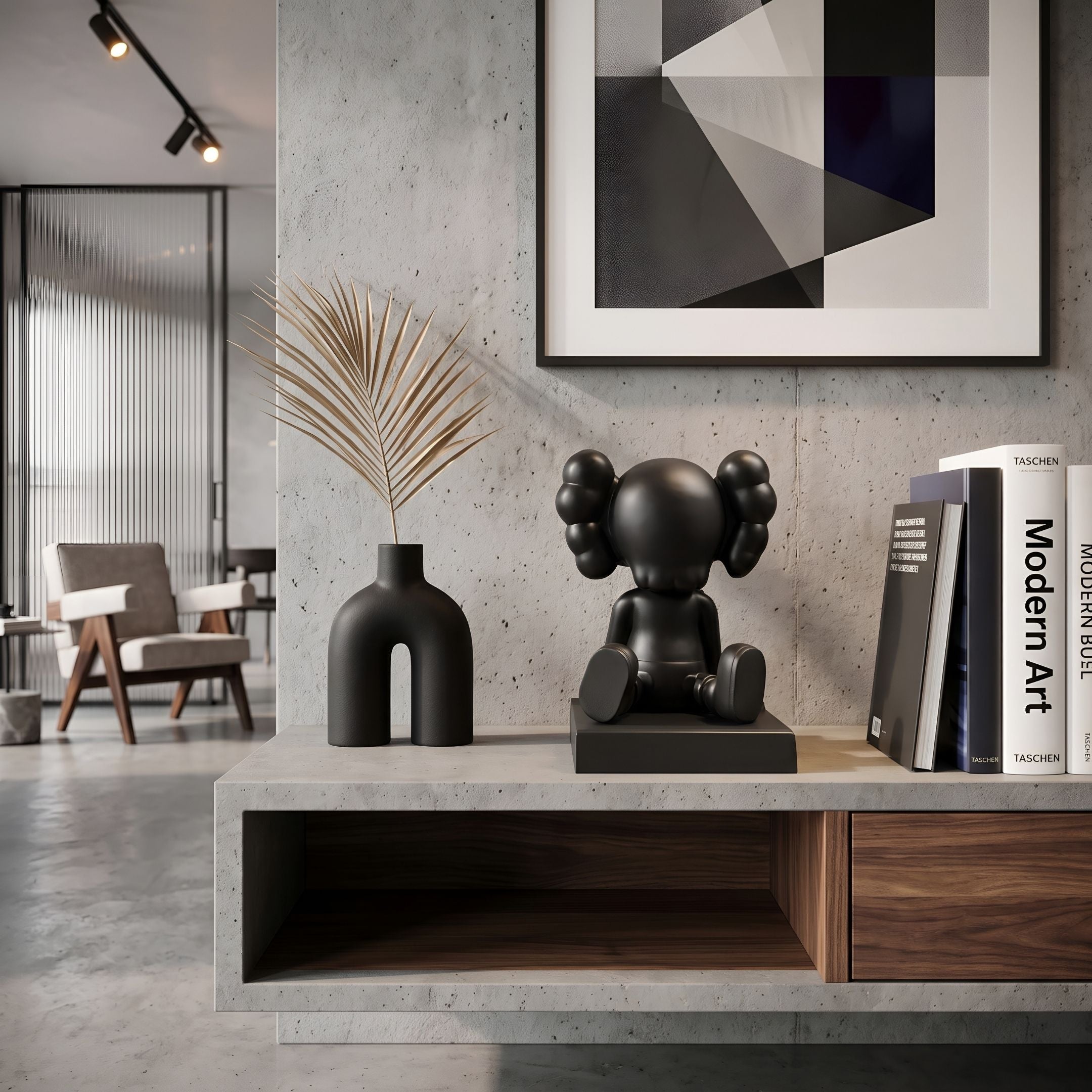 Midnight Black I Iconify Bobblehead Figure - 10cm, seated on a console shelf beside books, a dark arched vase, and framed geometric wall art.