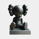 A 10cm Midnight Black Iconify Bobblehead Figure by Giant Sculptures, this resin collectible features a back view of a seated cartoon-like character with large round ears and no face, boasting modern design with legs stretched out on a rectangular base.