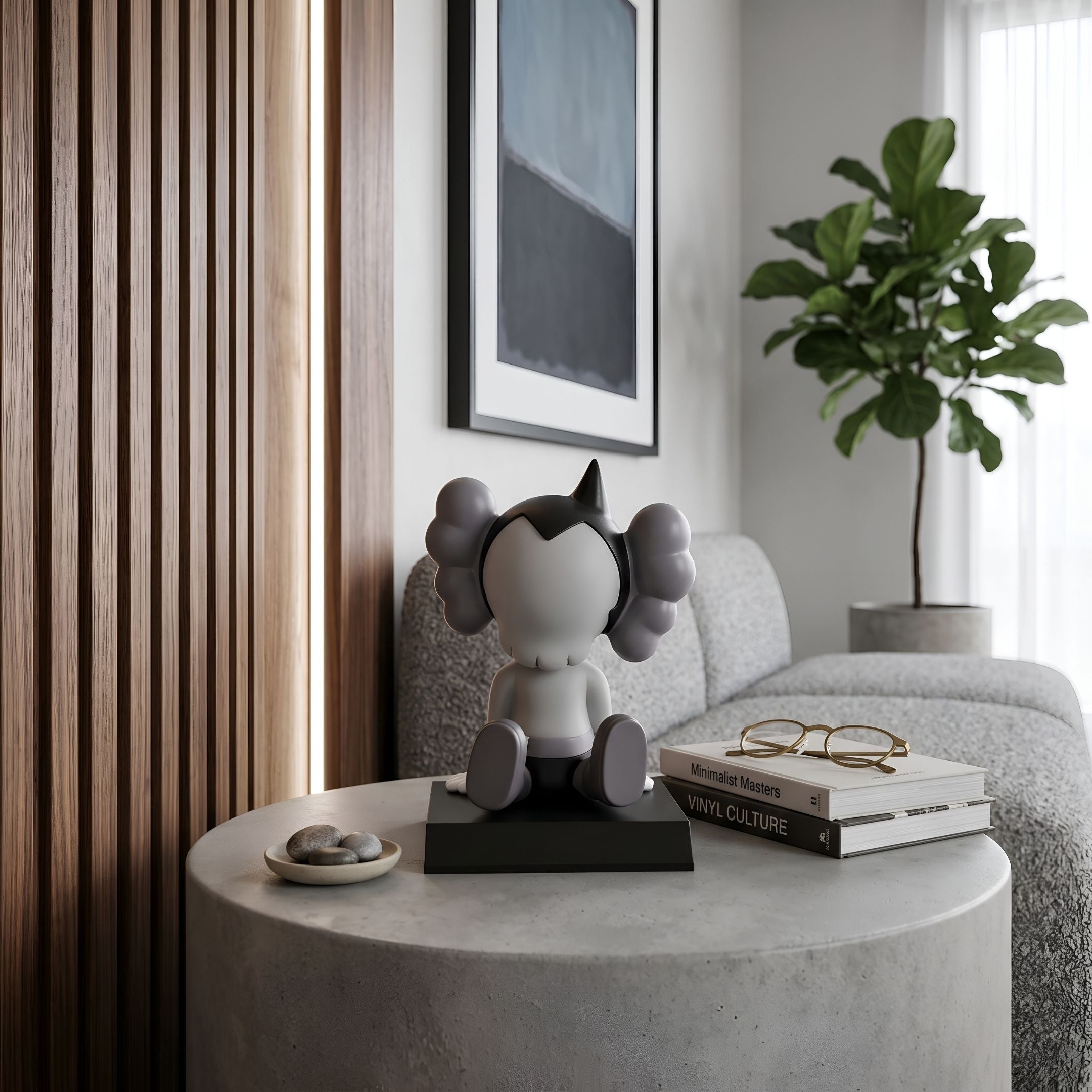 Slate Grey Iconify Bobblehead Cosmic Boy Figure, 10cm polyvinyl piece on a black base, displayed on a side table in a living room with a sofa and plant.
